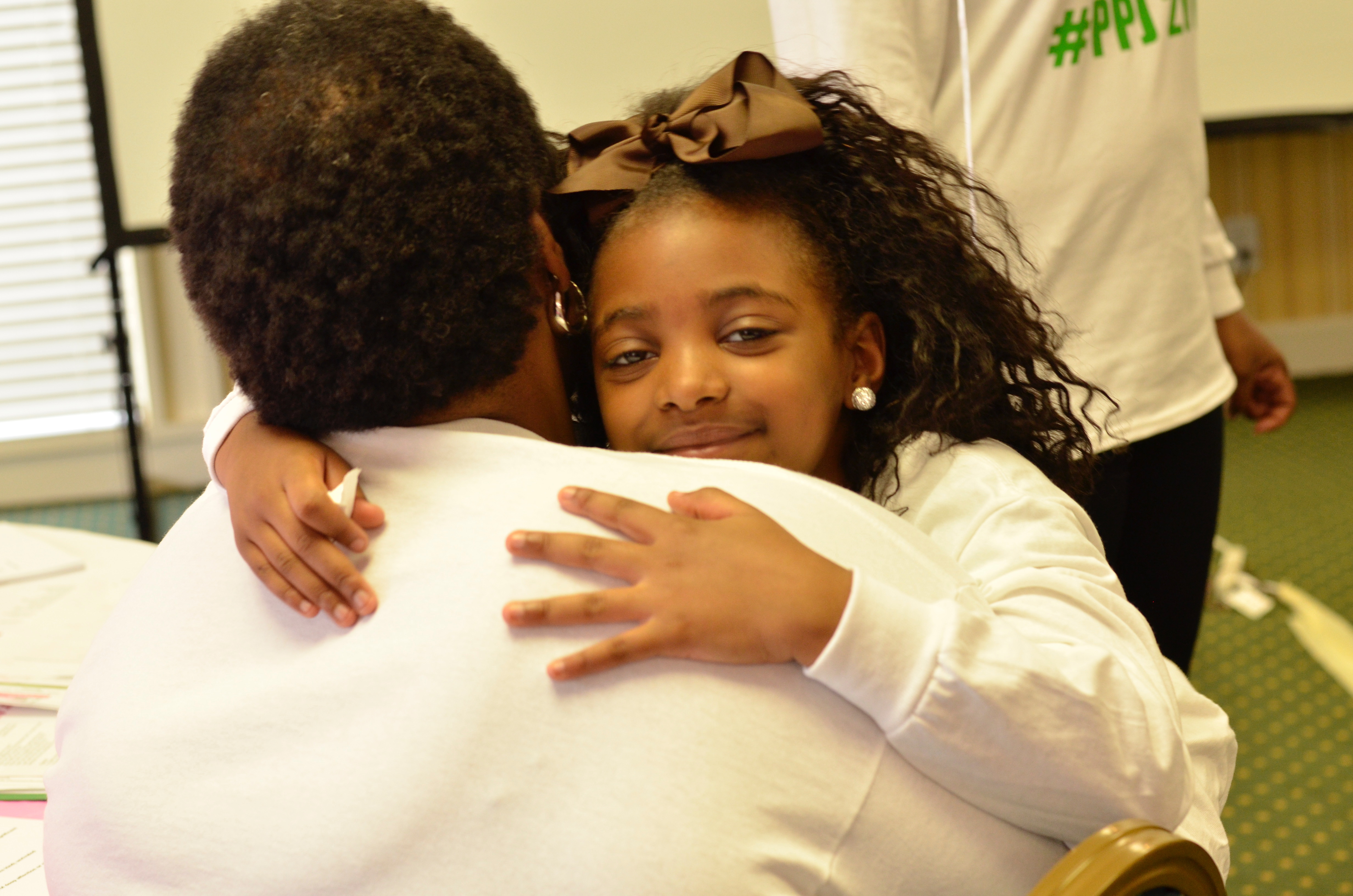 I Am B.E.A.U.T.I.F.U.L. co-founder Zenobia Edwards gets a hug from one of the girls in the non-profit's Beginnings program. The L in B.E.A.U.T.I.F.U.L. stands for LOVED. CONTRIBUTED