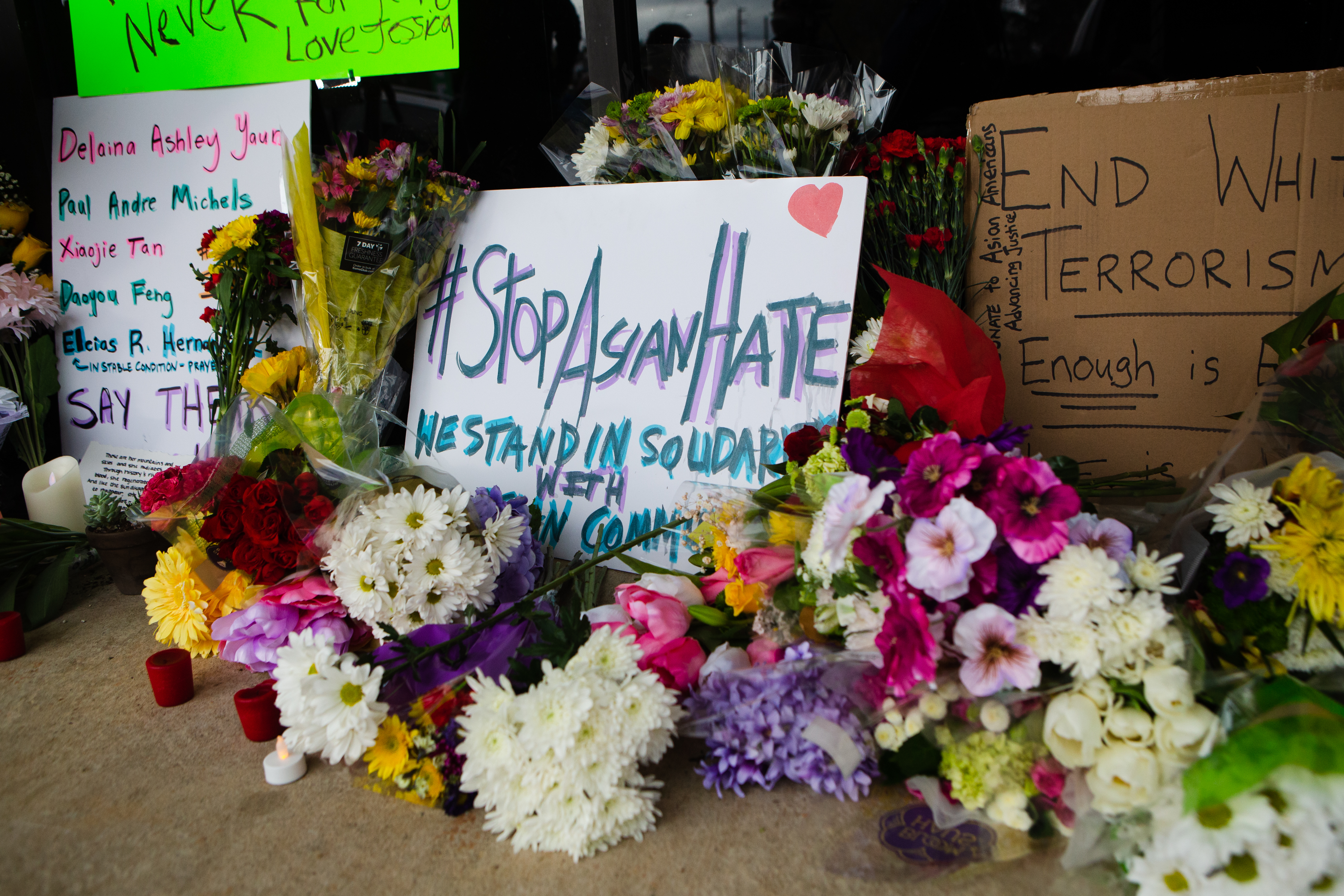 A memorial set up in front of Young's Asian Massage in Cherokee County honors the lives of Delaina Ashley Yaun, Paul Andre Michels, Xiaojie Tan and Daoyou Feng, who were shot and killed there, and others killed in Atlanta on Tuesday. Six of the eight victims were Asian women. (Christina Matacotta for The Atlanta Journal-Constitution)