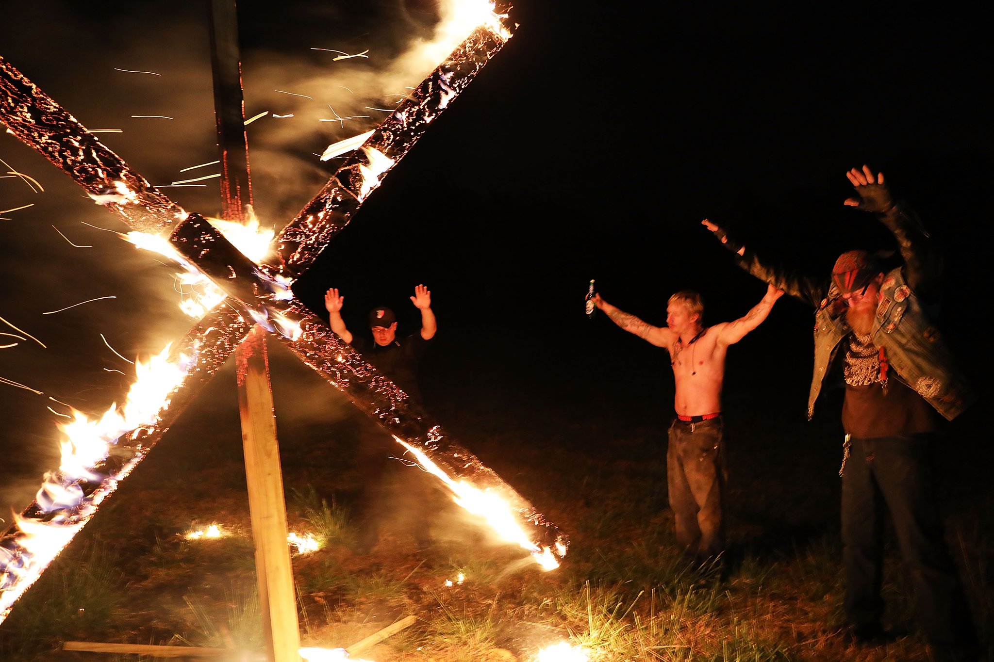 Members of the National Socialist Movement, a neo-Nazi group, hold a swastika-burning in Draketown, Ga., on April 21, 2018, following their rally that day in Newnan, Ga. (Photo by Spencer Platt/Getty Images)