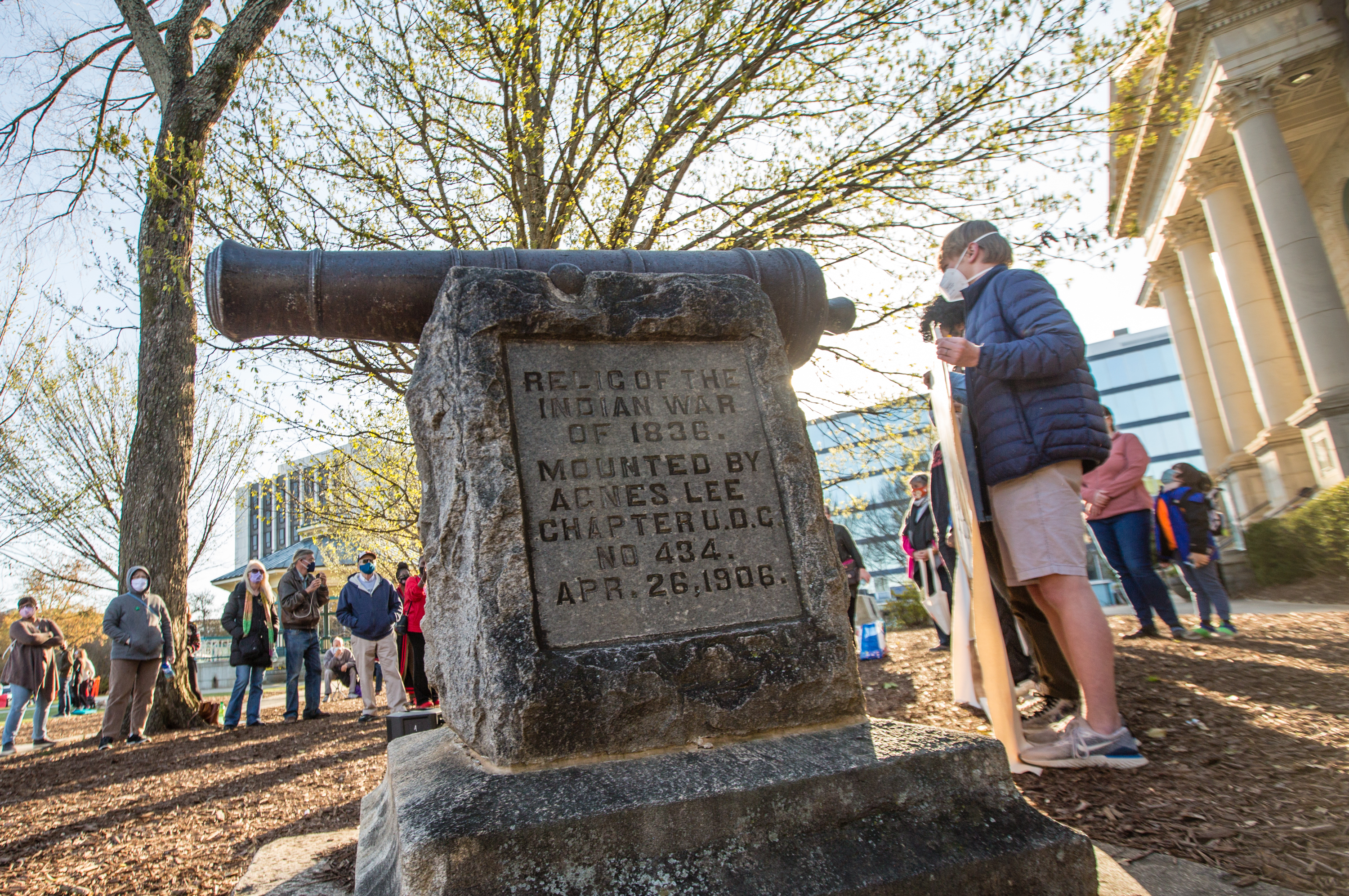 A rally in support of removal of a cannon in Decatur Square gathers in March 2021. The war relic serves as a monument in DeKalb County marking the end of the 1836 "Indian War." (Jenni Girtman for The Atlanta Journal-Constitution)