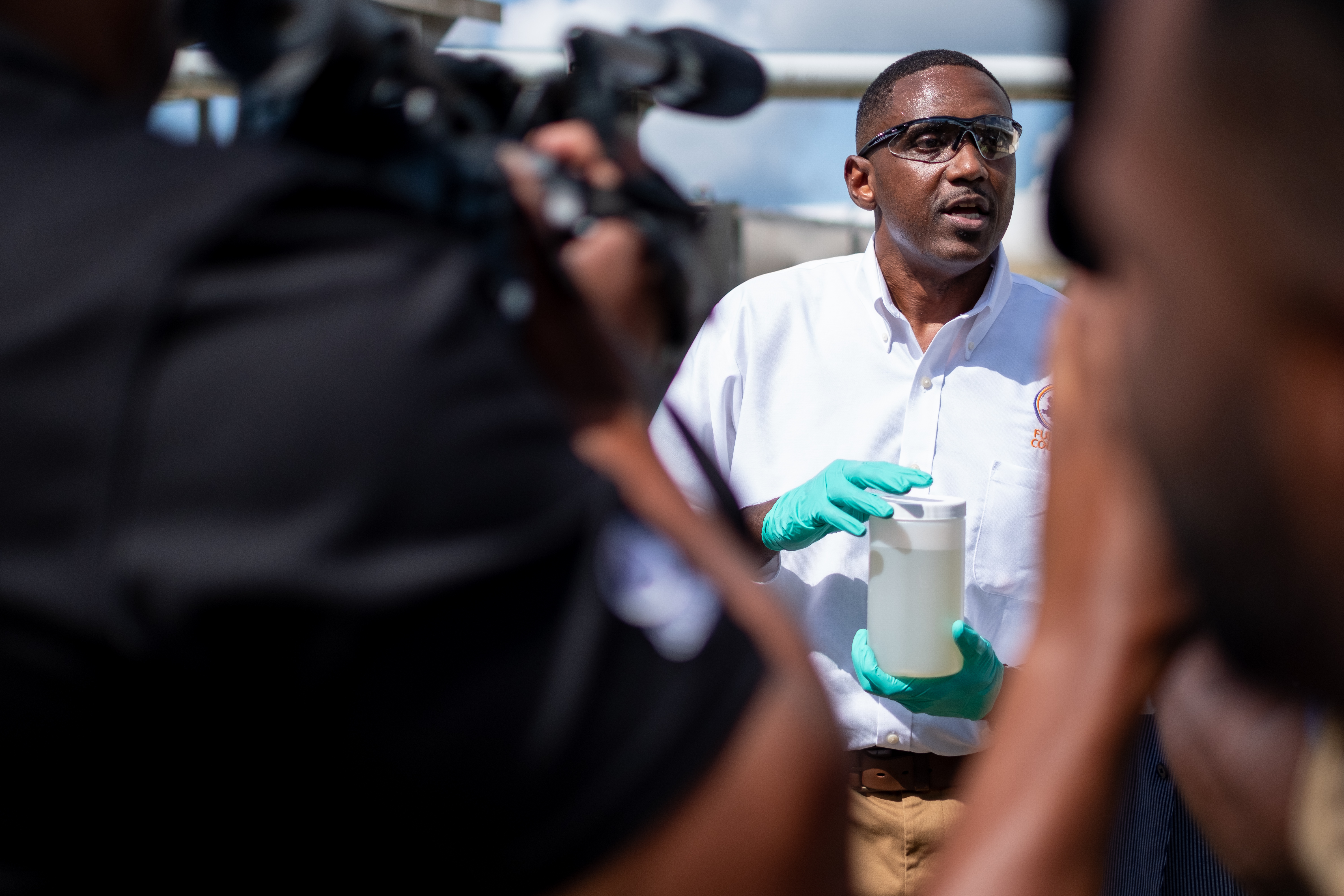 Fulton County Lab Manager Patrick Person holds a sample of sewage at the Camp Creek Water Reclamation Facility on Tuesday morning, July 26, 2022. The sample is used to test for Covid-19 and monkey pox infections in the community. Ben Gray for the Atlanta Journal-Constitution