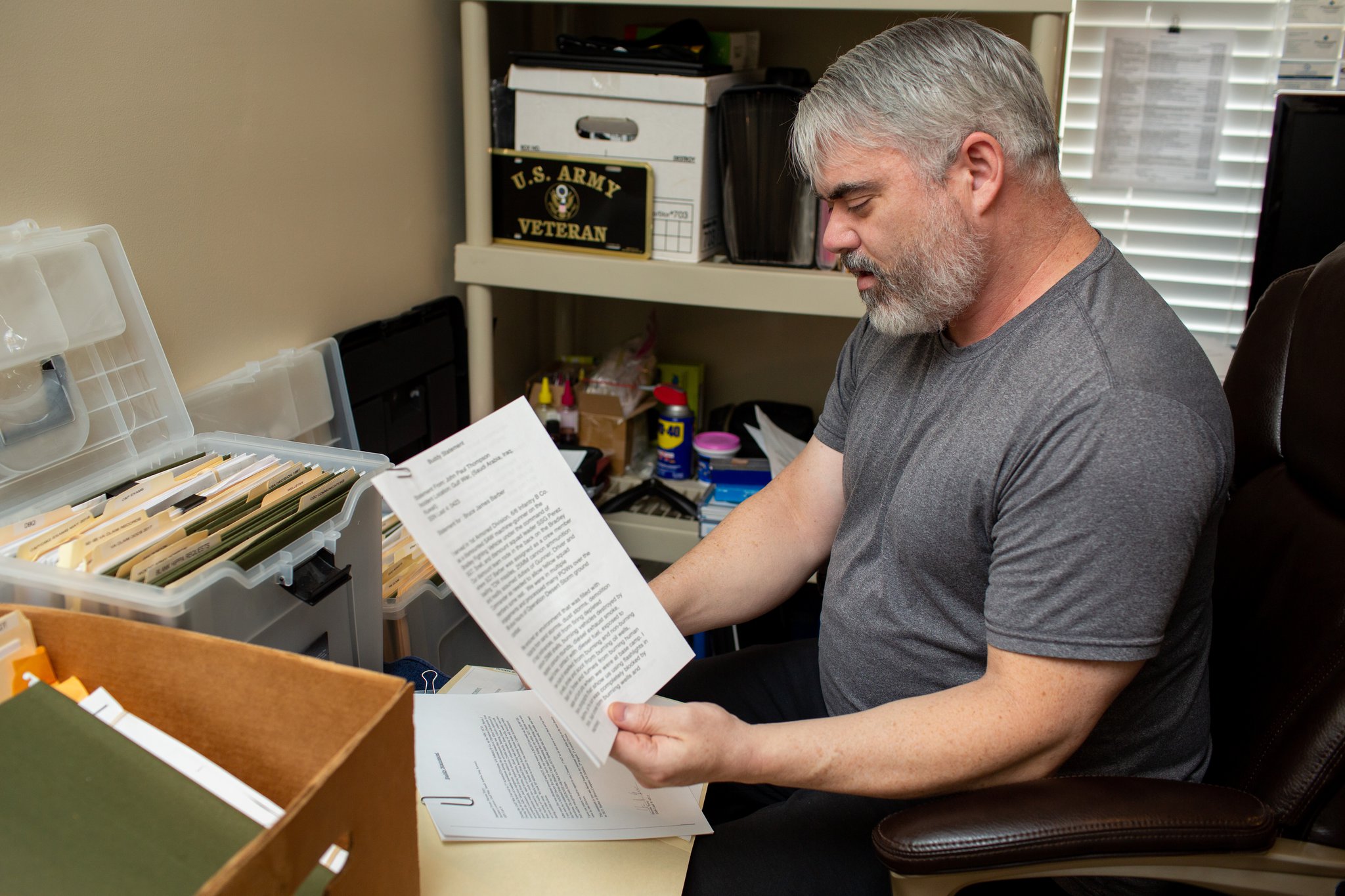 Bruce Barber sifts through medical records and communication documents that he has generated trying to get health care from Veterans Affairs programs. Barber, a Gulf War veteran, and others in Georgia report long delays in getting to new doctors through the MISSION Act. (Photo/Rebecca Wright for the AJC)