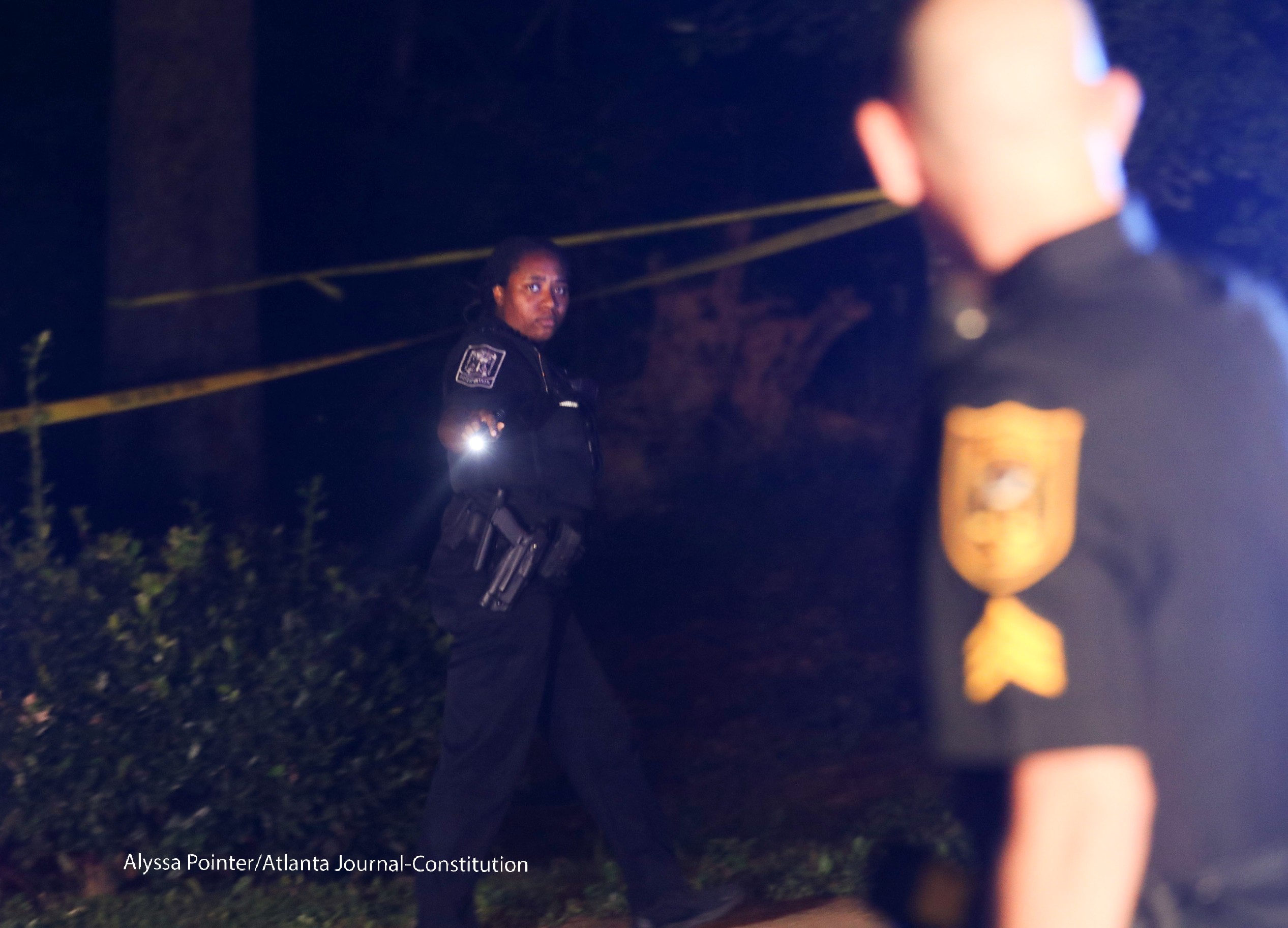 DeKalb police officers work the scene at a condominium community. ALYSSA POINTER / ALYSSA.POINTER@AJC.COM