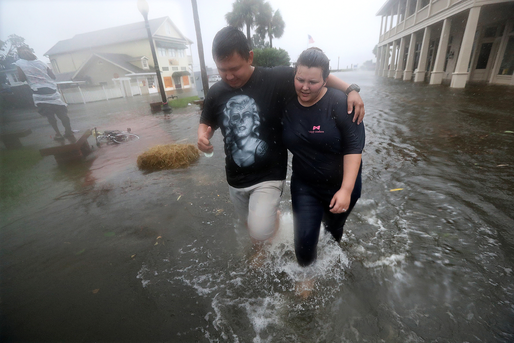 Residents Michael & Tori Munton make their way down a flooded street in historic Saint Marys during the storm surge from Hurricane Matthew. Made with Canon EOS 1DX Mark II camera, a 16-35mm zoom lens at 16 mm, 1/1000 second, F/5.6, ISO 5000. Curtis Compton /ccompton@ajc.com