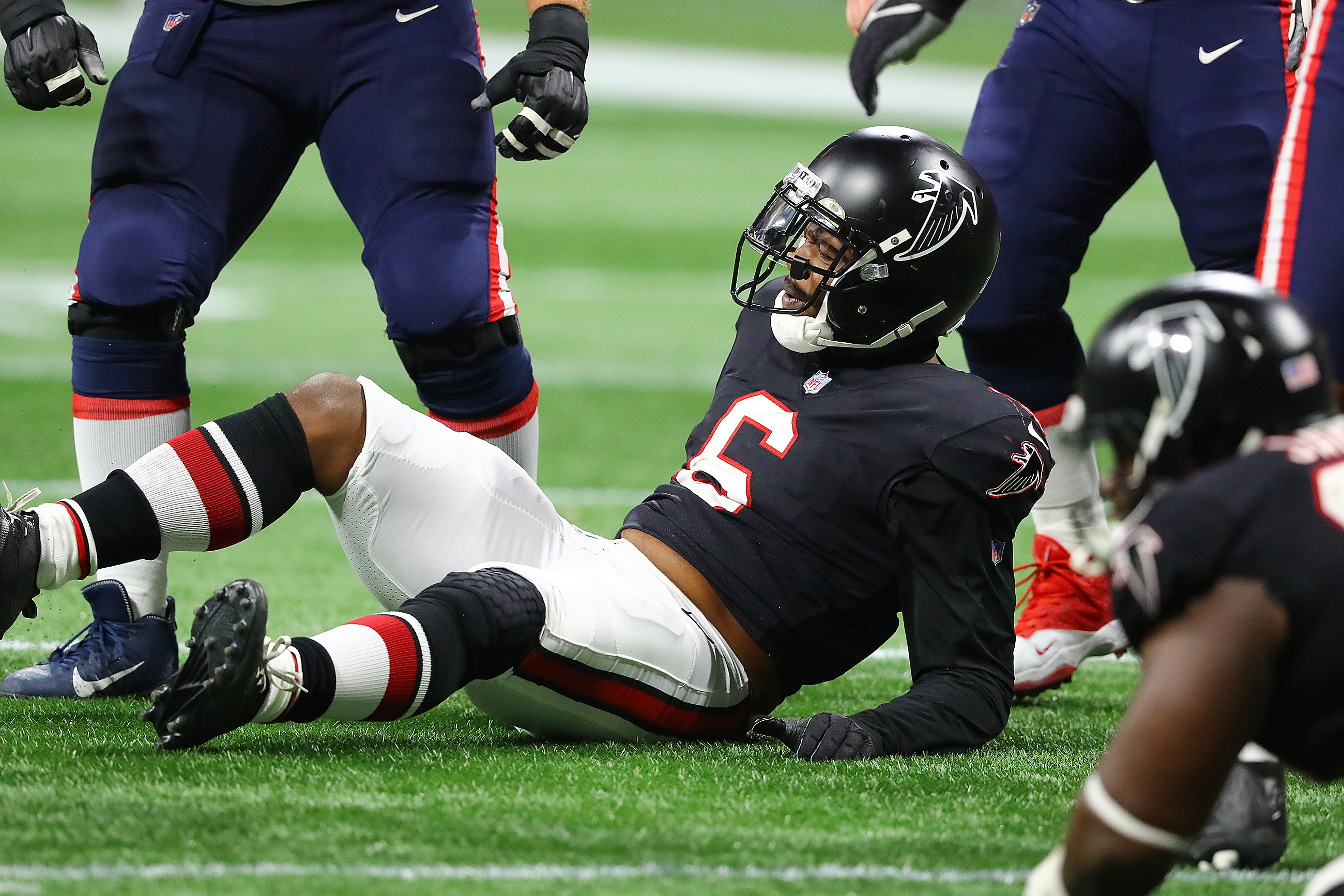 Falcons outside linebacker Dante Fowler is knocked to the turf by Patriots offensive lineman Ted Karras on another unsuccessful pass rush attempt during the second half in a NFL football game on Thursday, Nov. 18, 2021, in Atlanta. “Curtis Compton / Curtis.Compton@ajc.com”