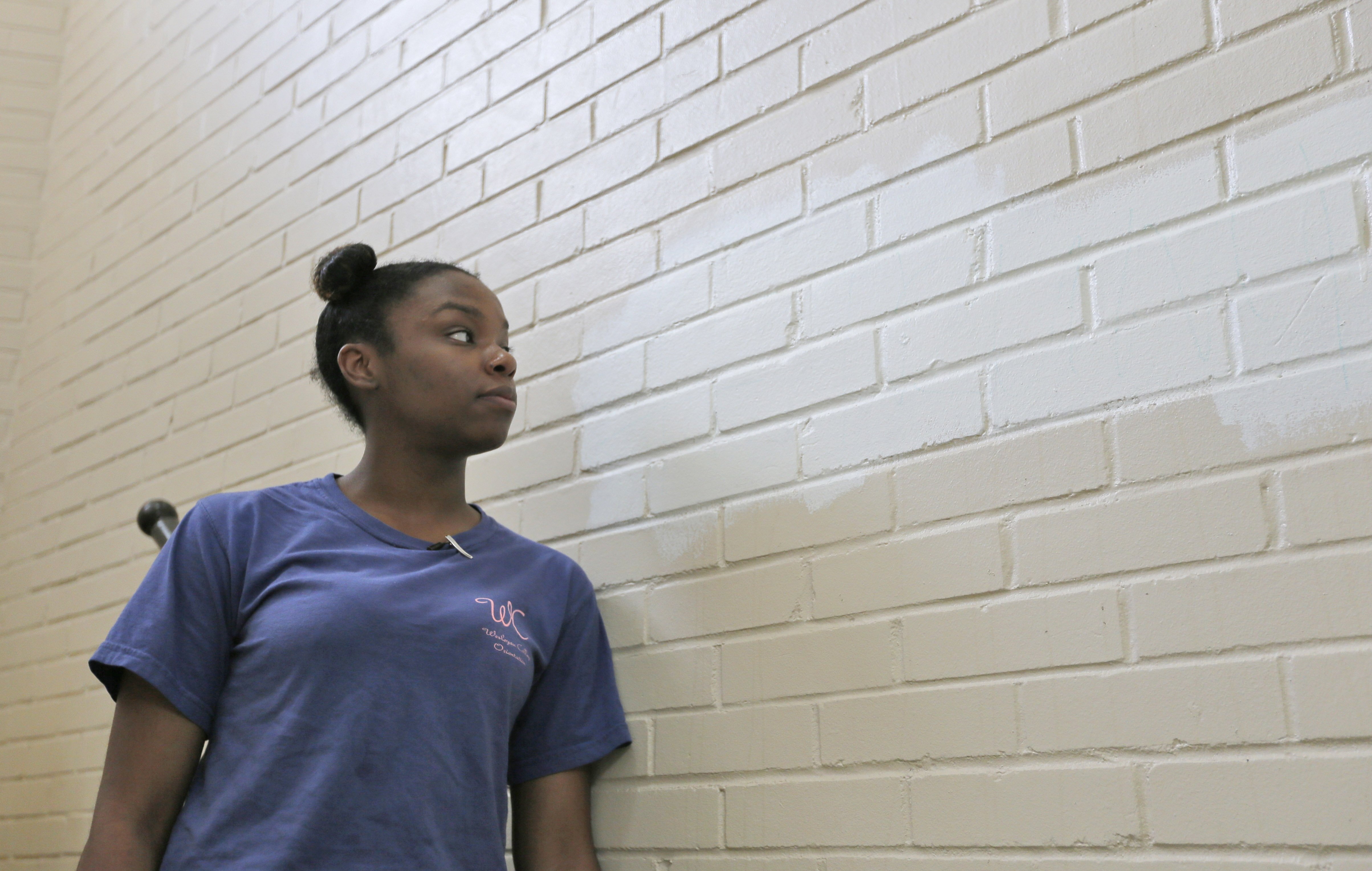 Wesleyan student Kennedy Jones visits the stairway where racist language appeared (now painted over with white paint) and started a racially charged incident at the school. BOB ANDRES /BANDRES@AJC.COM