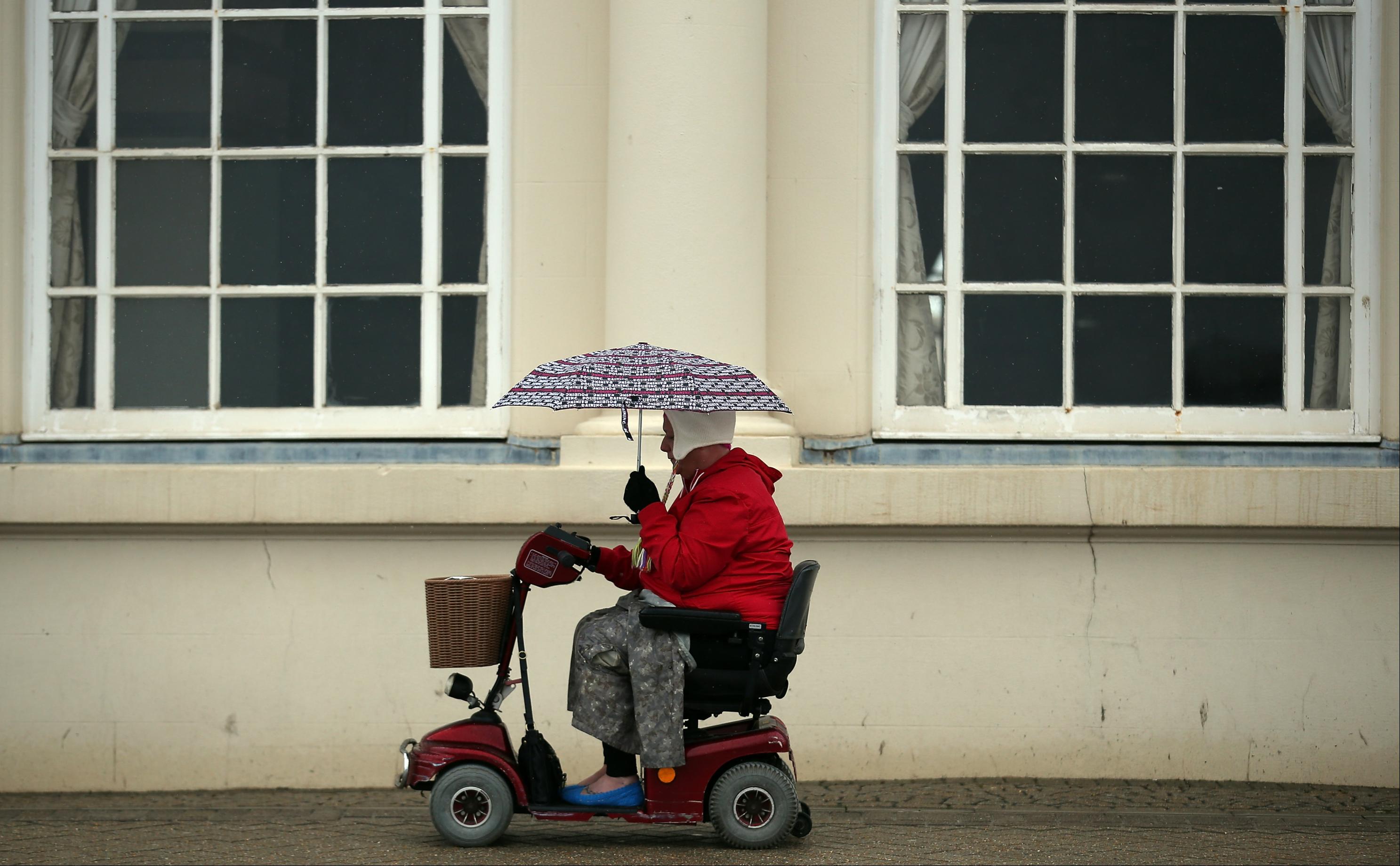 Elderly woman navigates traffic in Memphis on mobility