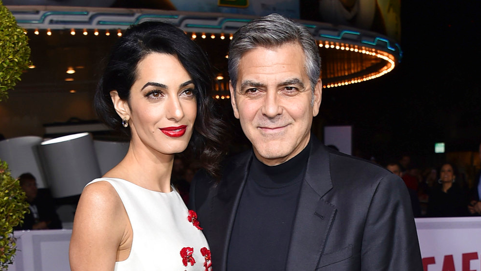FILE - In this Feb. 1, 2016 file photo, Amal Clooney, left, and George Clooney arrive at the world premiere of "Hail, Caesar!" in Los Angeles. George and Amal Clooney have welcomed twins Ella and Alexander Clooney. The pair was born Tuesday morning, June 6, 2017, according to George Clooney's publicist Stan Rosenfield. (Photo by Jordan Strauss/Invision/AP, File)