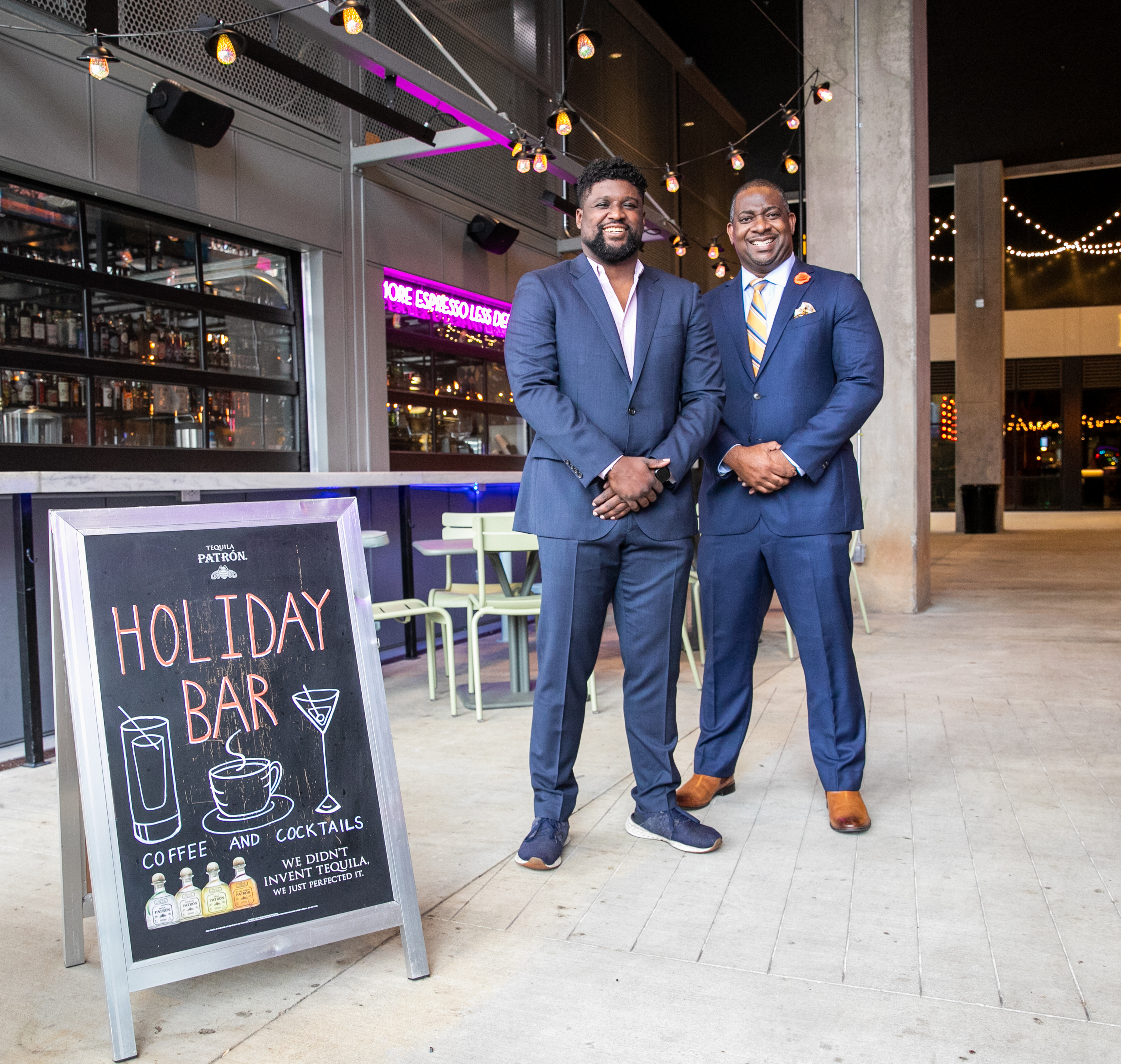 Investor Armond Davis, right, managing partner of The Paragon Group, and "A Seat at The Table Capital" owner Camaran Burke, left, catch up at Holiday Bar in West Midtown, one of Burke's four bars in Atlanta, on Wednesday, March 9, 2022. Davis is an investor working with black-owned businesses to fill the gap many African Americans face when seeking financing. Holiday Bar at Howell Mill and 14th offers coffee, cocktails and great patio space. (Jenni Girtman for The Atlanta Journal-Constitution)