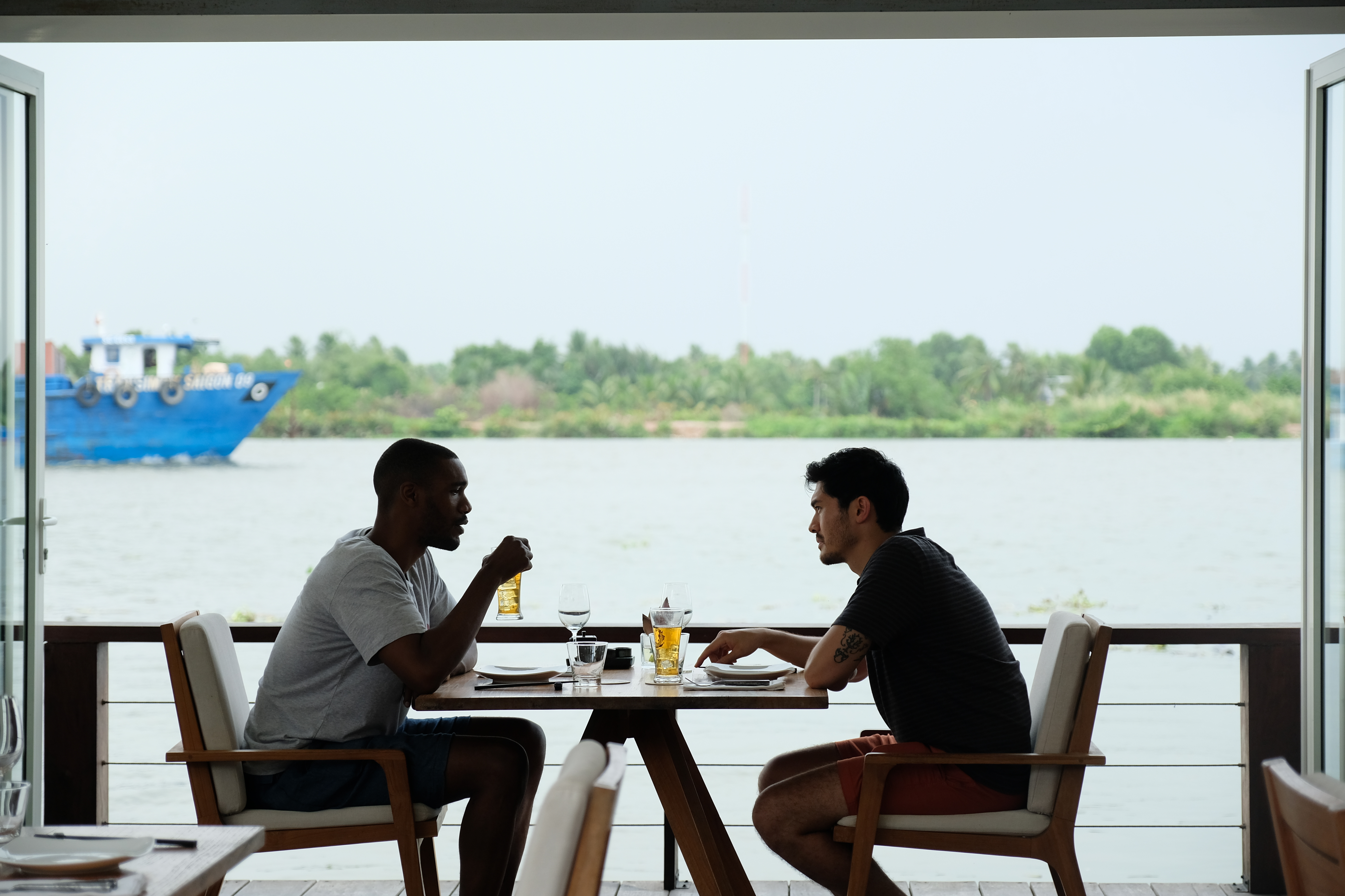 In "Monsoon," Kit (Henry Golding, right) and Lewis (Parker Sawyers) bond over being fish out of water in Vietnam. 
Courtesy of Dat Vu