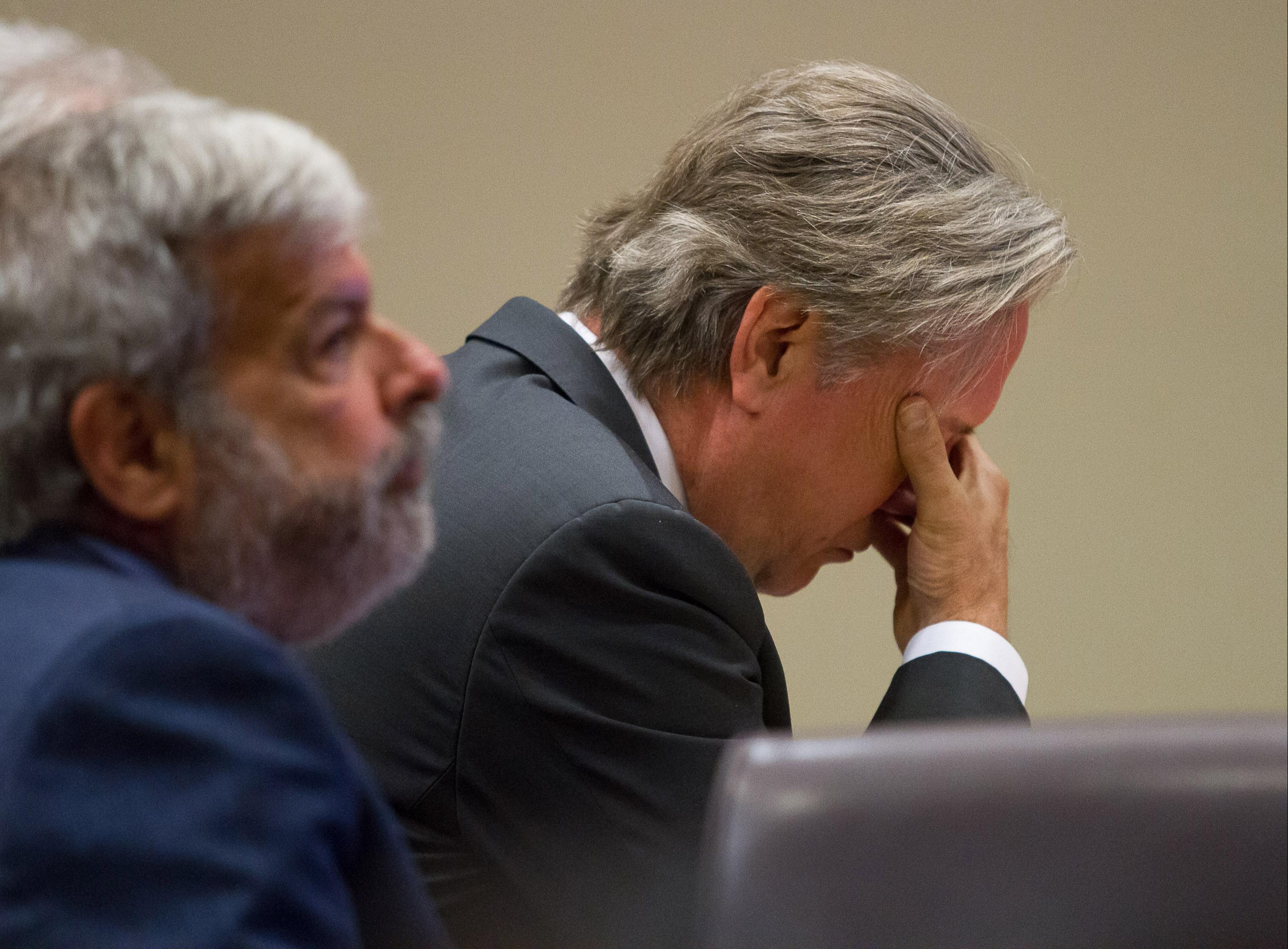Former DeKalb County Police Officer Robert Olsen listens to testimony during his trial at the DeKalb County Superior Court on Monday. At left is his attorney Don Samuel. STEVE SCHAEFER / SPECIAL TO THE AJC
