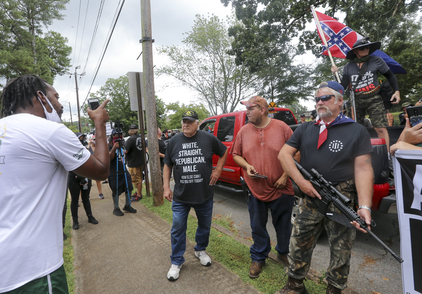 8/15/20 - Stone Mountain, GA - Counter protesters face off with protesters as several far-right groups, including militias and white supremacists, rally Saturday in the town of Stone Mountain, and a broad coalition of leftist anti-racist groups organized a counter-demonstration there after local authorities closed Stone Mountain park. Jenni Girtman for the Atlanta Journal Constitution