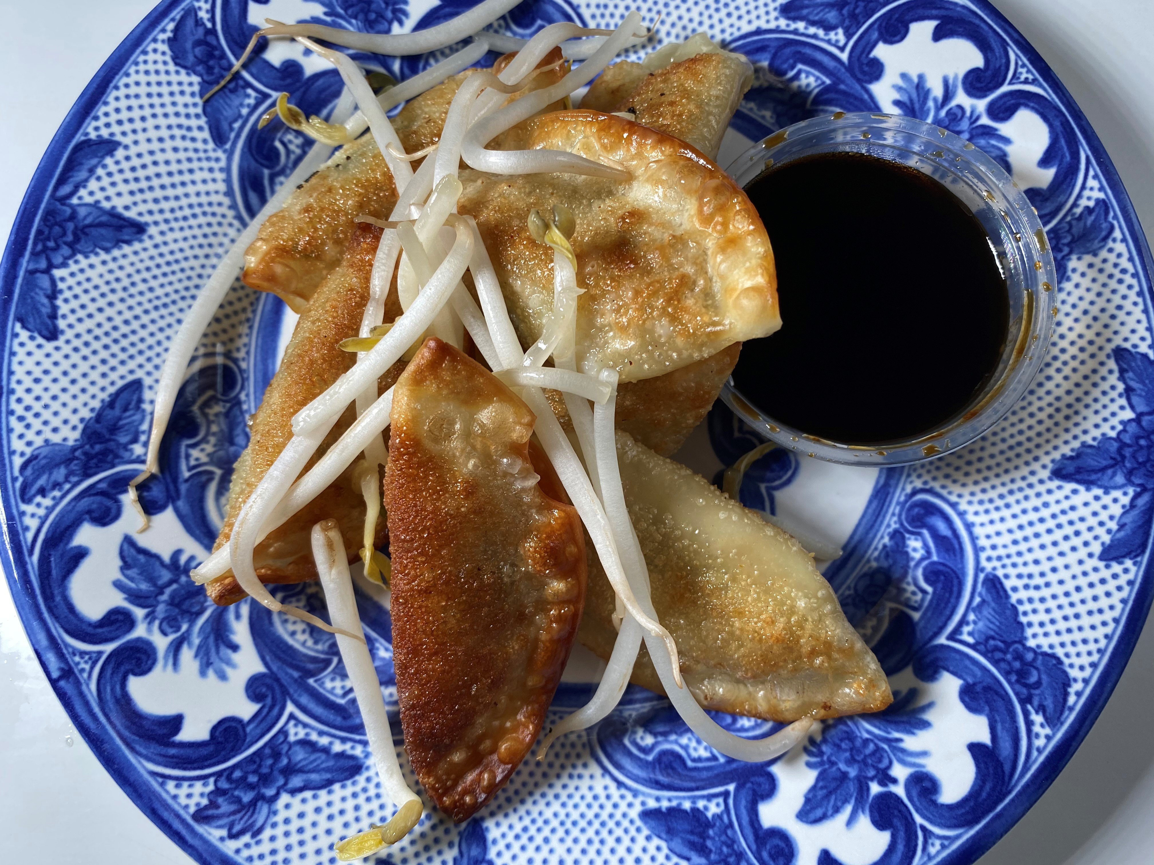 Spoon Eastside's pan-fried pot stickers with vegetables are topped with bean sprouts. Bob Townsend for The Atlanta Journal-Constitution