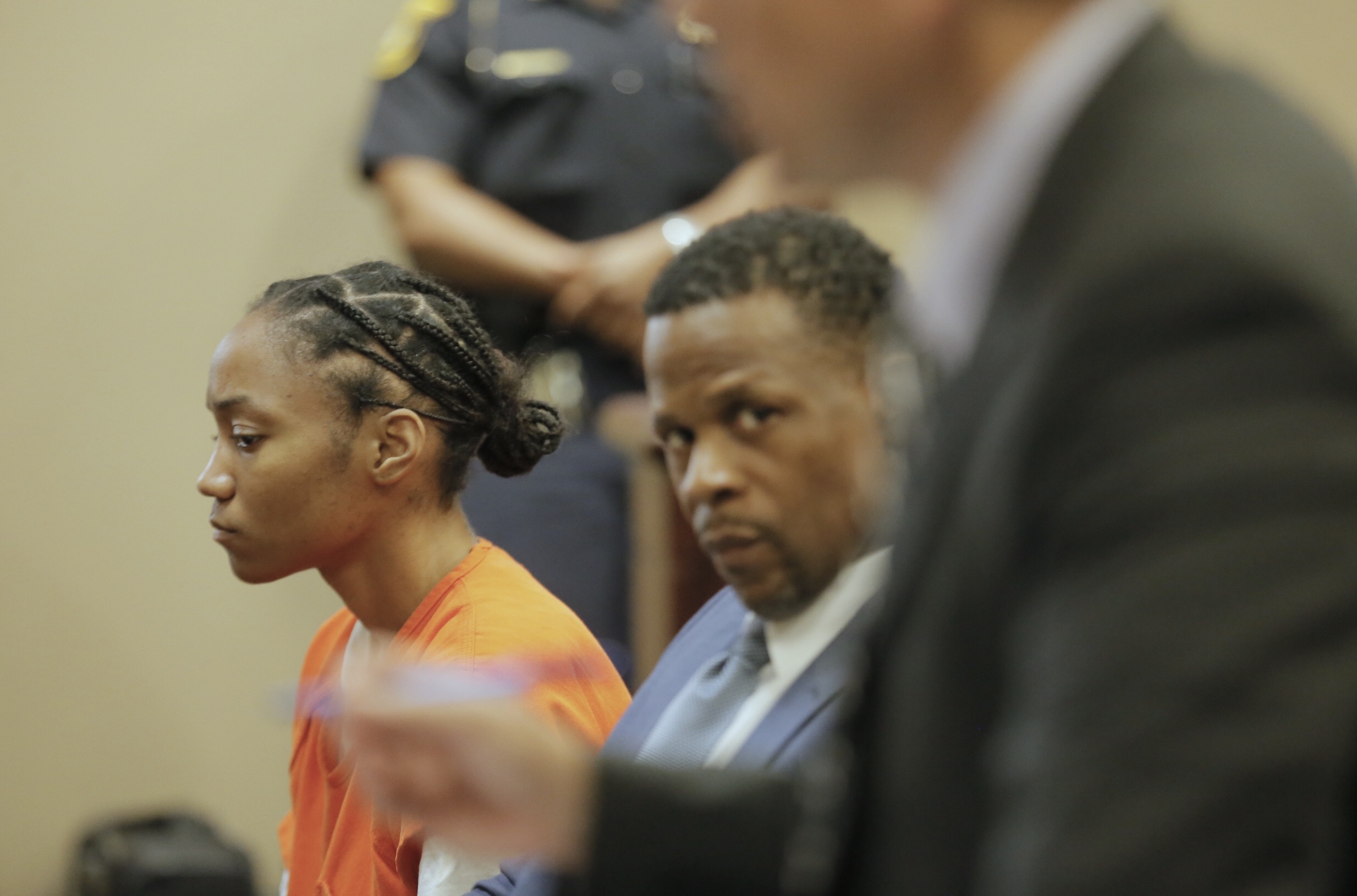 Dijanelle Fowler, left, sits in a preliminary hearing on Aug. 3, 2017.