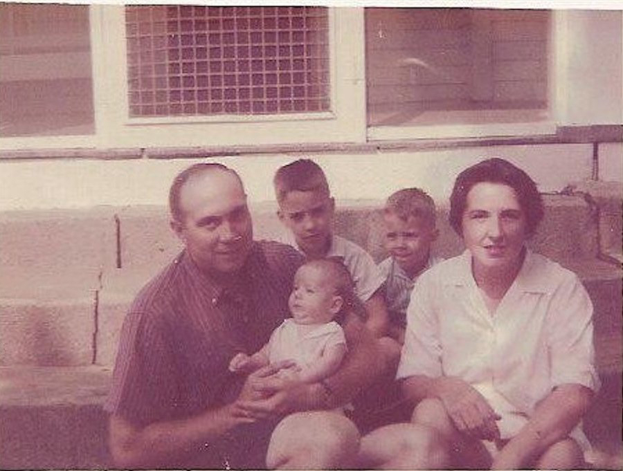 The King boys, Bill (second from left), Jonathan (centre) and Timothy (in his father's arms), sit with their parents, William D. King and Mollie Parry King, on their grandmother's porch .  (Courtesy of the King family)