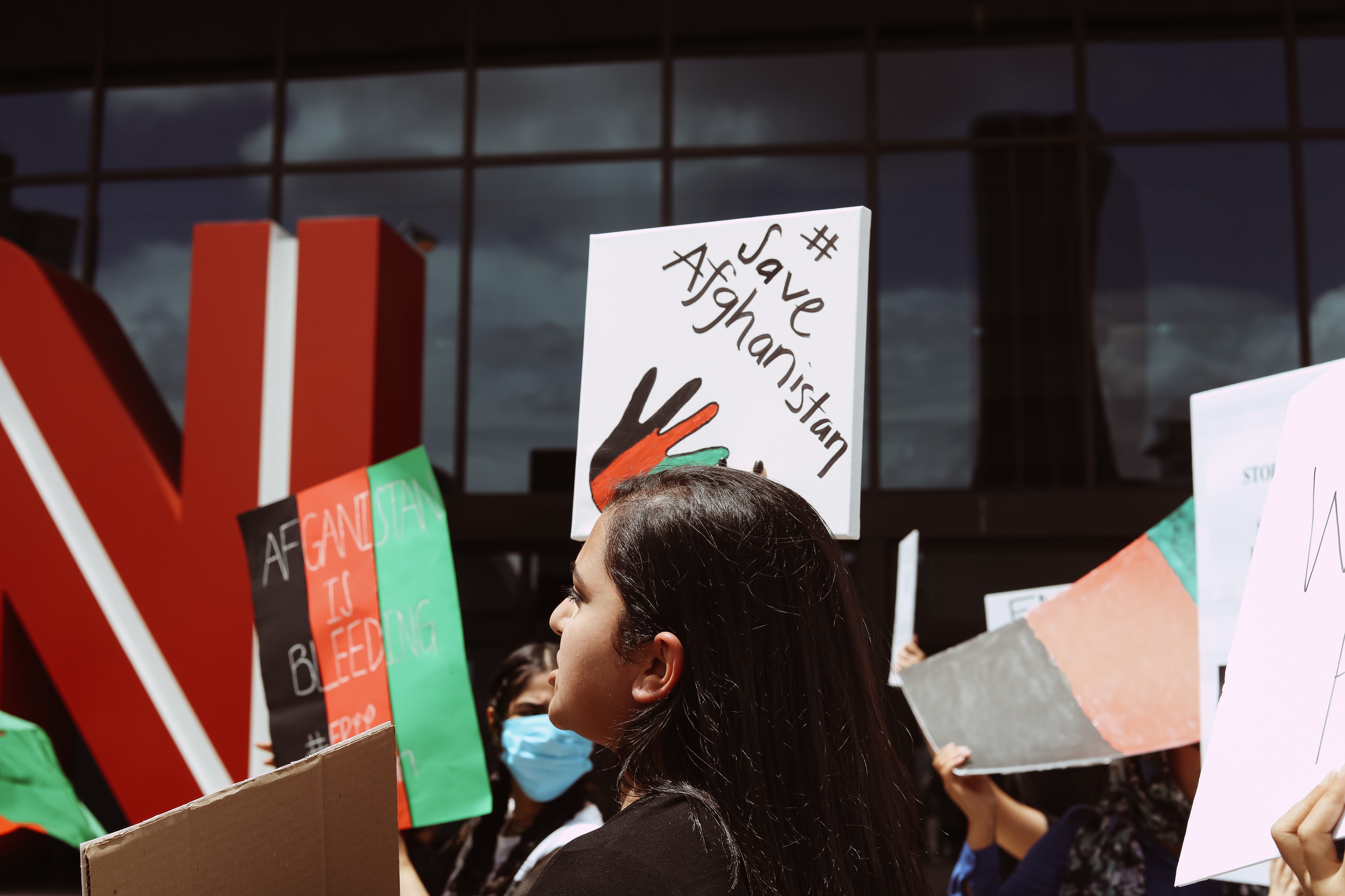 Demonstrators raise signs in downtown Atlanta on Sunday, Aug. 15, 2021, to bring attention to the situation in Afghanistan.