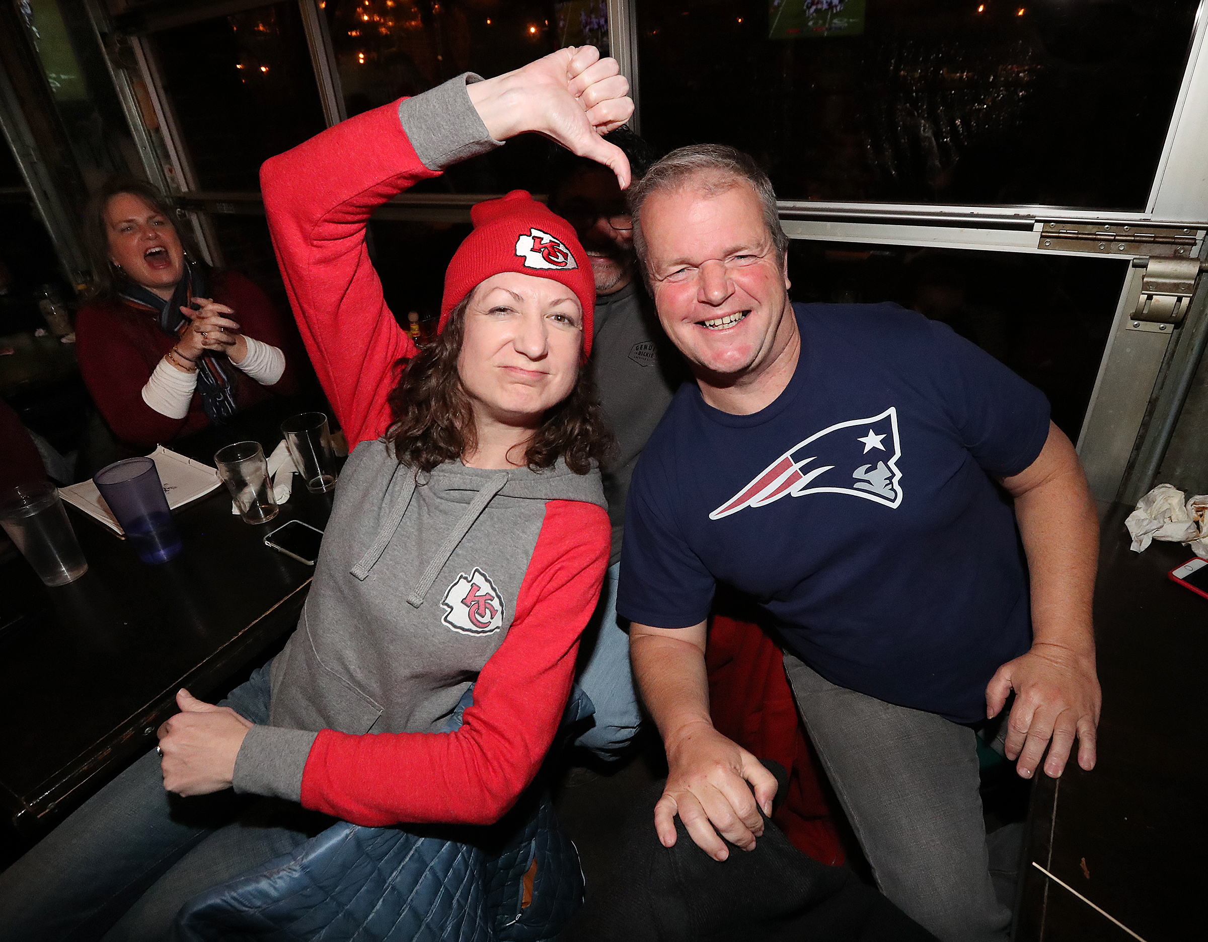 Chiefs fan Becky Taylor and Patriots fan Patrick Hughes face off while watching the AFC Championship game at Midway Pub with a trip to the Super Bowl in Atlanta on the line on Sunday, Jan. 20, 2019, in Atlanta. (Photo: Curtis Compton/ccompton@ajc.com)