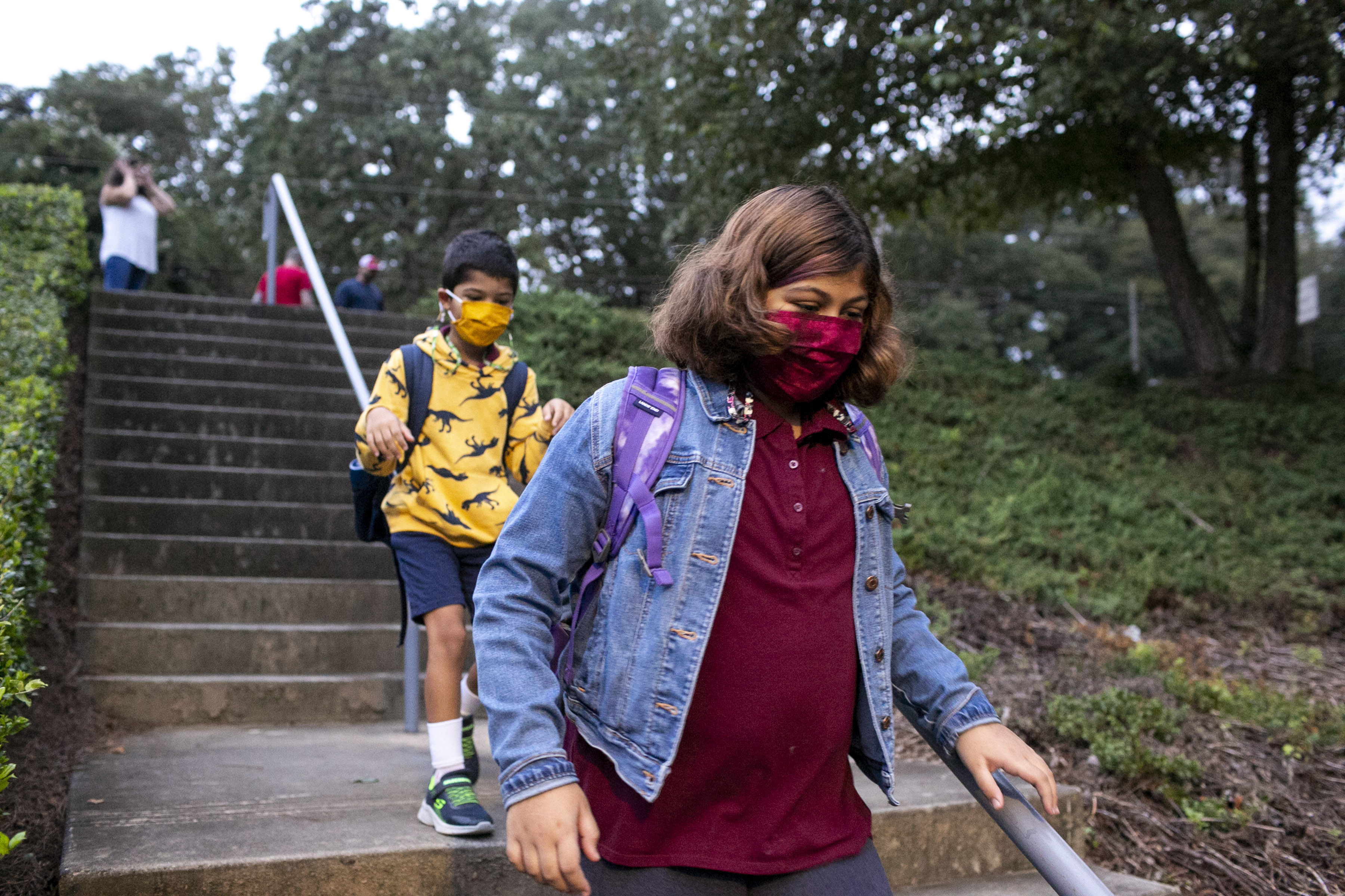 Dahlia and Omar Varghese walk to Burgess Elementary School in East Atlanta on Thursday, September 9, 2021. Serene Varghese’s daughter, Dahlia, got Covid-19 during the first week of school about a month ago. (Rebecca Wright for the Atlanta Journal-Constitution)