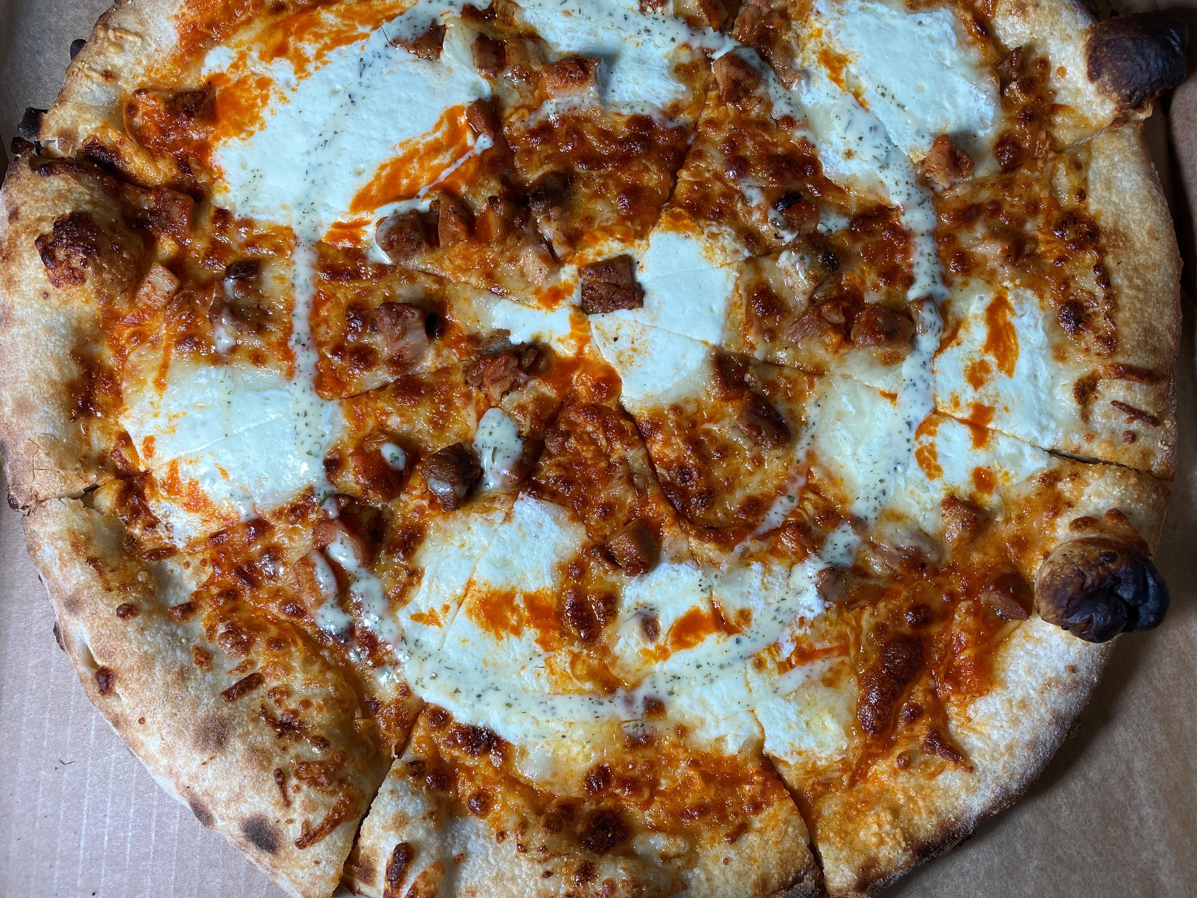 New Realm's buffalo chicken pizza is made with Alfredo, buffalo mozzarella, Parmesan reggiano, and ranch. Bob Townsend for The Atlanta Journal-Constitution