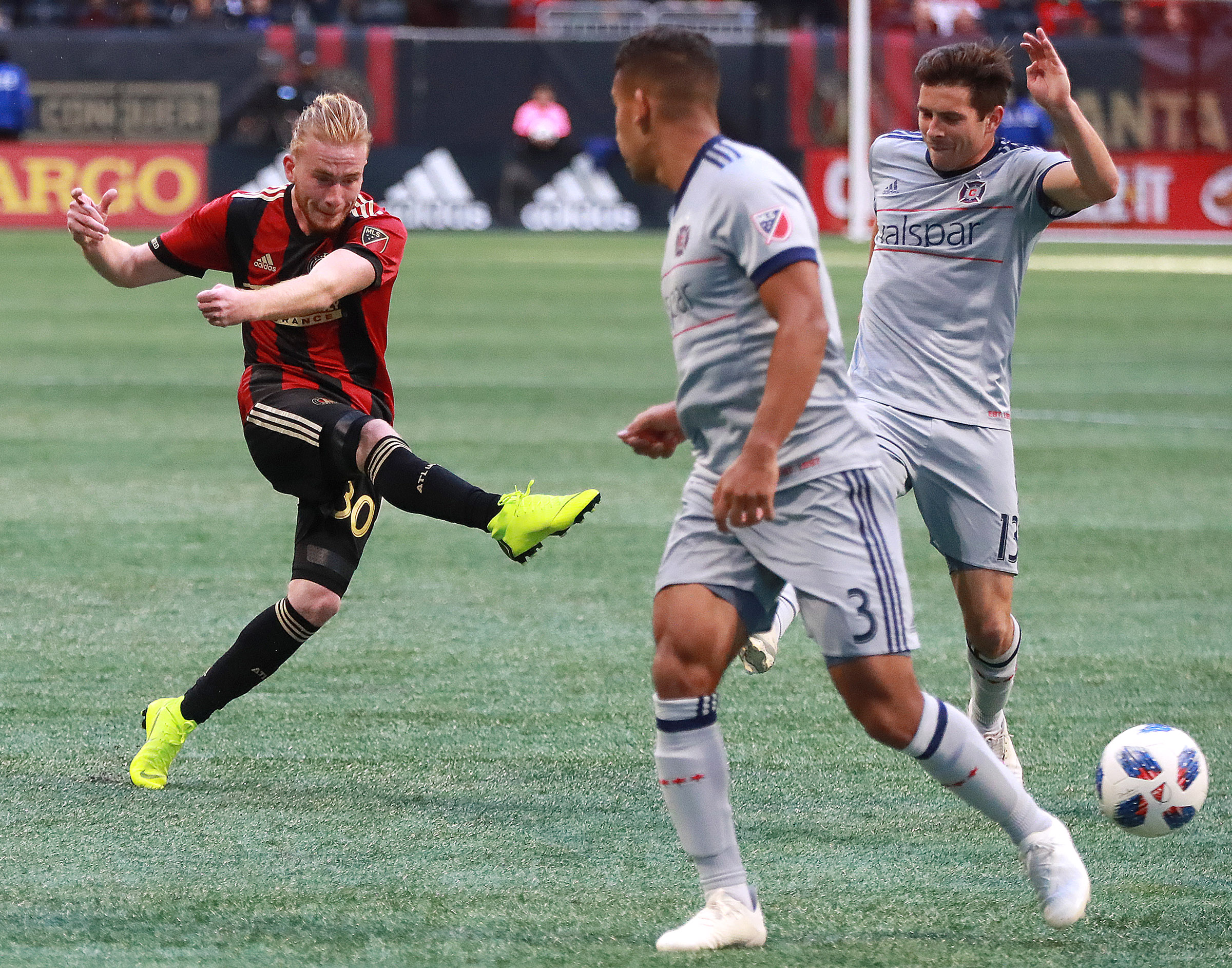 October 21, 2018 Atlanta: Atlanta United midfielder Andrew Carleton gets off a shot on goal between Chicago Fire defenders Brandon Vincent and Brandt Bronico during the second half in a MLS soccer match on Sunday, Oct 21, 2018, in Atlanta. Curtis Compton/ccompton@ajc.com
