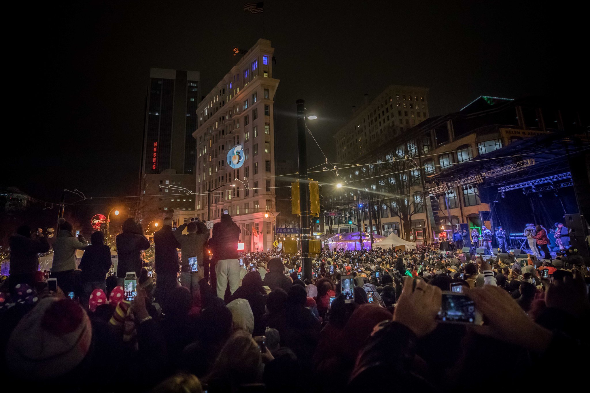 People celebrate as 2018 arrives with the Peach Drop 2017 at Wooddruff Park, Dec. 31, 2017, in Atlanta. BRANDEN CAMP / SPECIAL