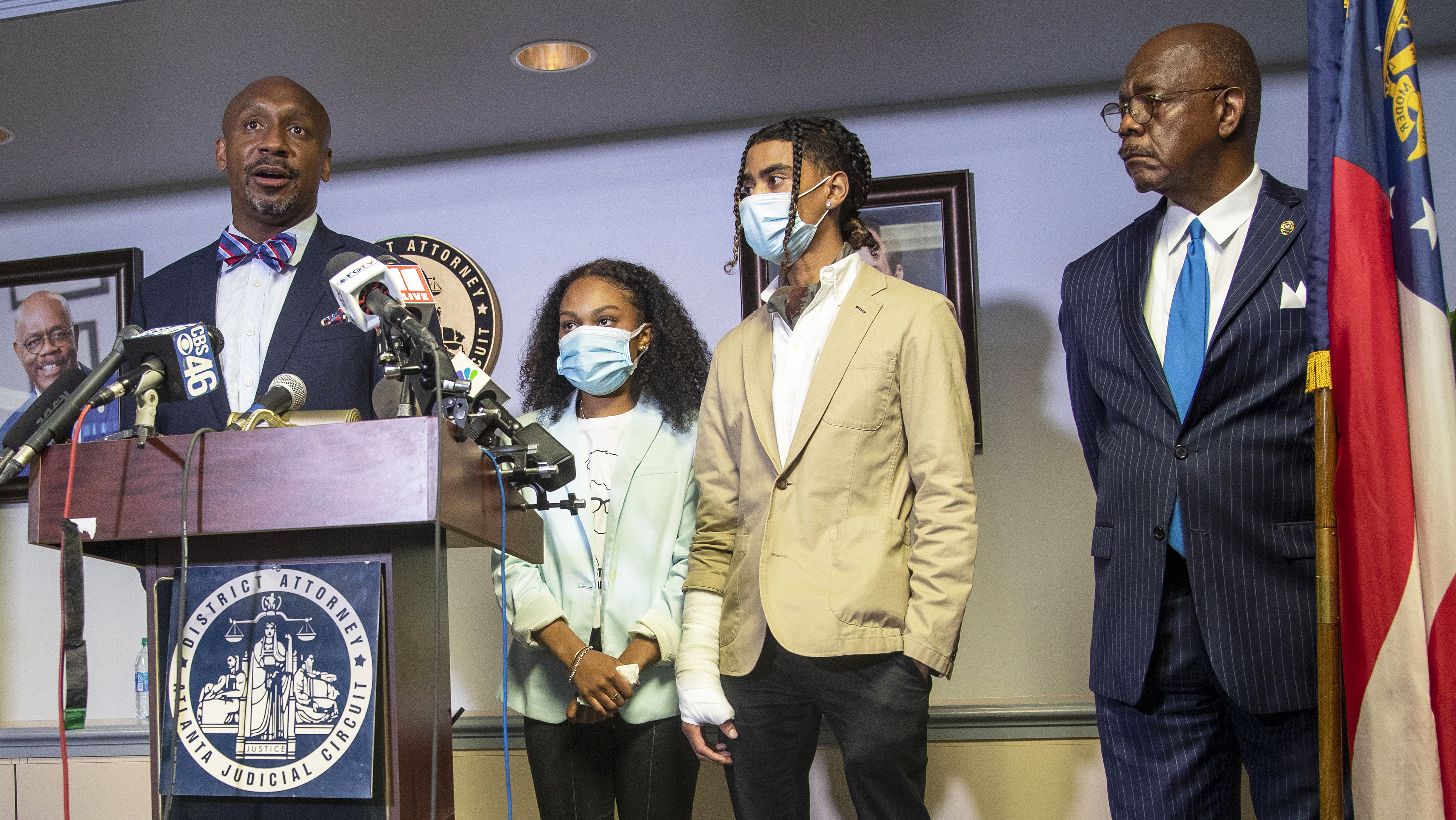 Attorney Mawuli Mel Davis (left) speaks on behalf of Taniyah Pilgrim (second from left) and Messiah Young (second from right)during a press conference by the Fulton County District Attorney's Office in Atlanta, Monday, June 2, 2020. District Attorney Paul Howard and members of the Fulton County District Attorney's Office are pressing charges against 6 Atlanta Police Officers for their involvement in the assault and property damage to Taniyah Pilgrim and Messiah Young. Attorney Mawuli Mel Davis is representing Messiah Young. (ALYSSA POINTER / ALYSSA.POINTER@AJC.COM)