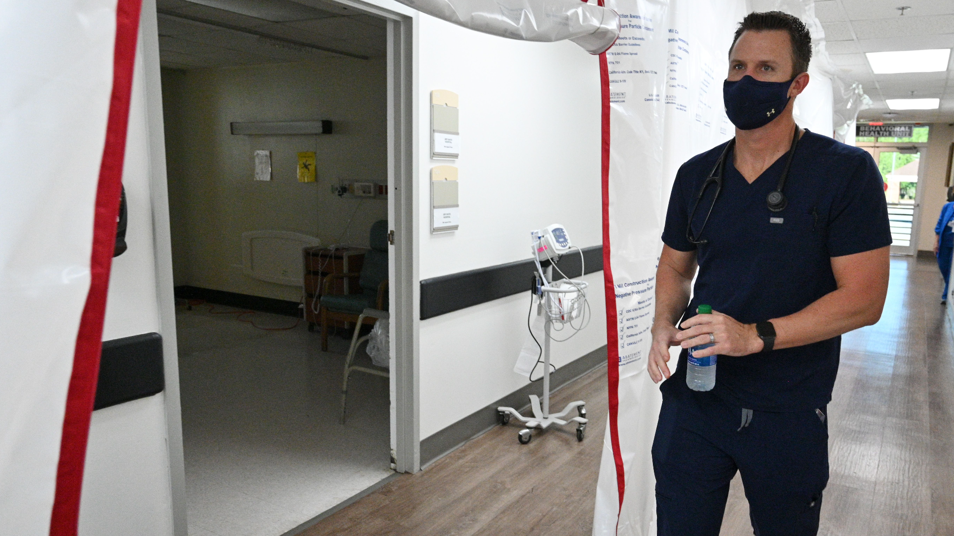 Dr. Jason Laney walks back to an intensive care unit (ICU) at Jeff Davis Hospital in Hazlehurst on Monday, September 13, 2021. Dr.Laney, a family medicine doctor who is the closest thing this tiny rural Georgia hospital has to a doctor trained in critical care, has been leading the charge against Covid-19, sleeping 3 hours a night. (Hyosub Shin / Hyosub.Shin@ajc.com)