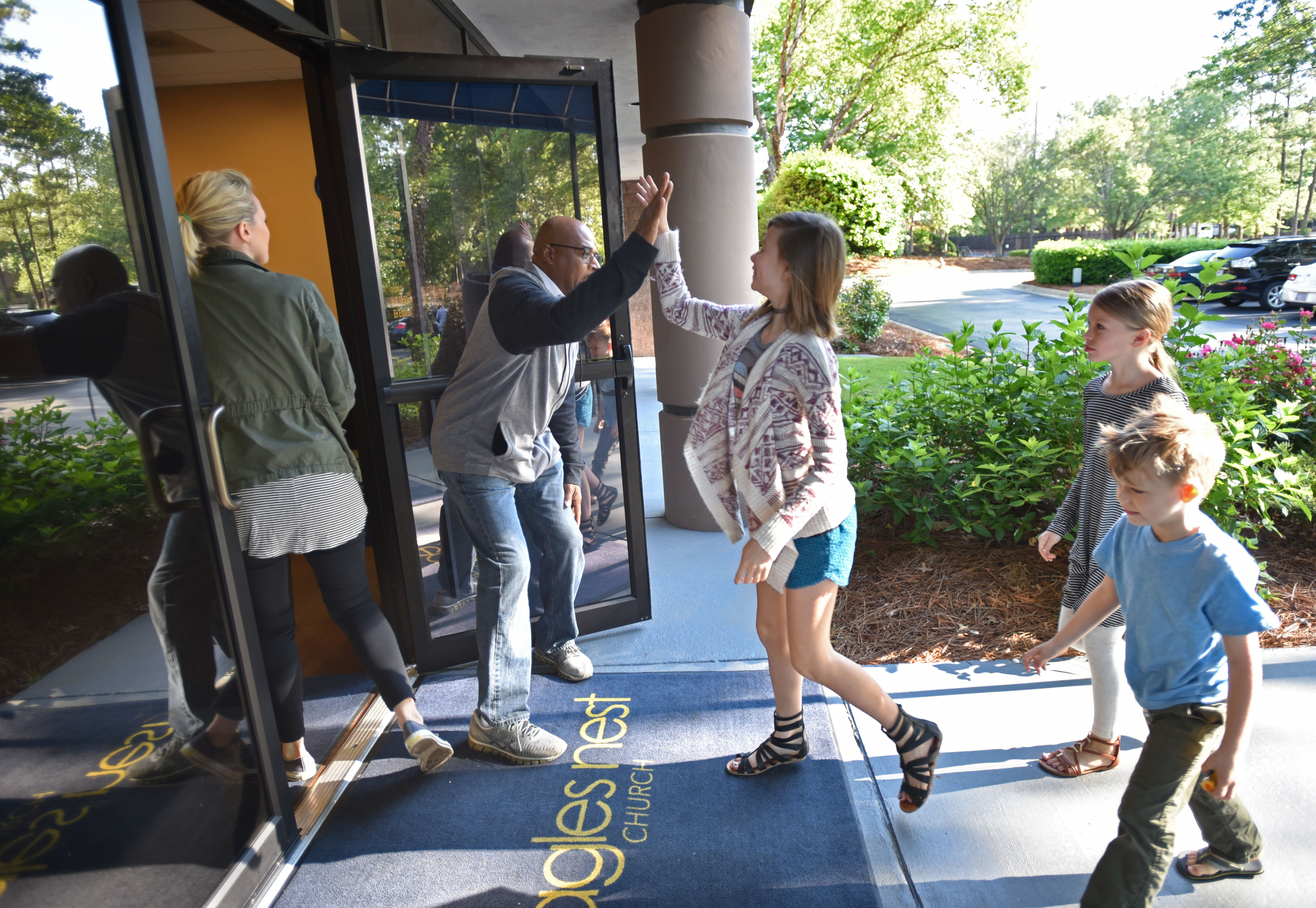 Anthony Kirk welcomes young church members before their joint service at Eagles Nest Church in Roswell on Saturday, May 6, 2017. HYOSUB SHIN / HSHIN@AJC.COM