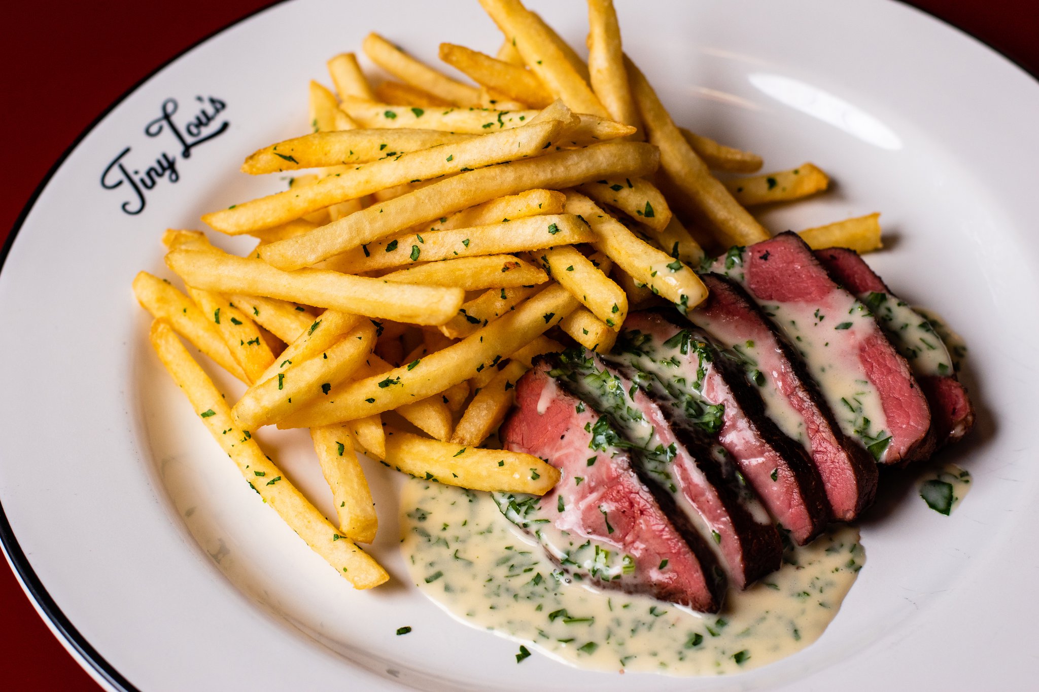The steak frites dish at Tiny Lou’s is as classic as it gets.