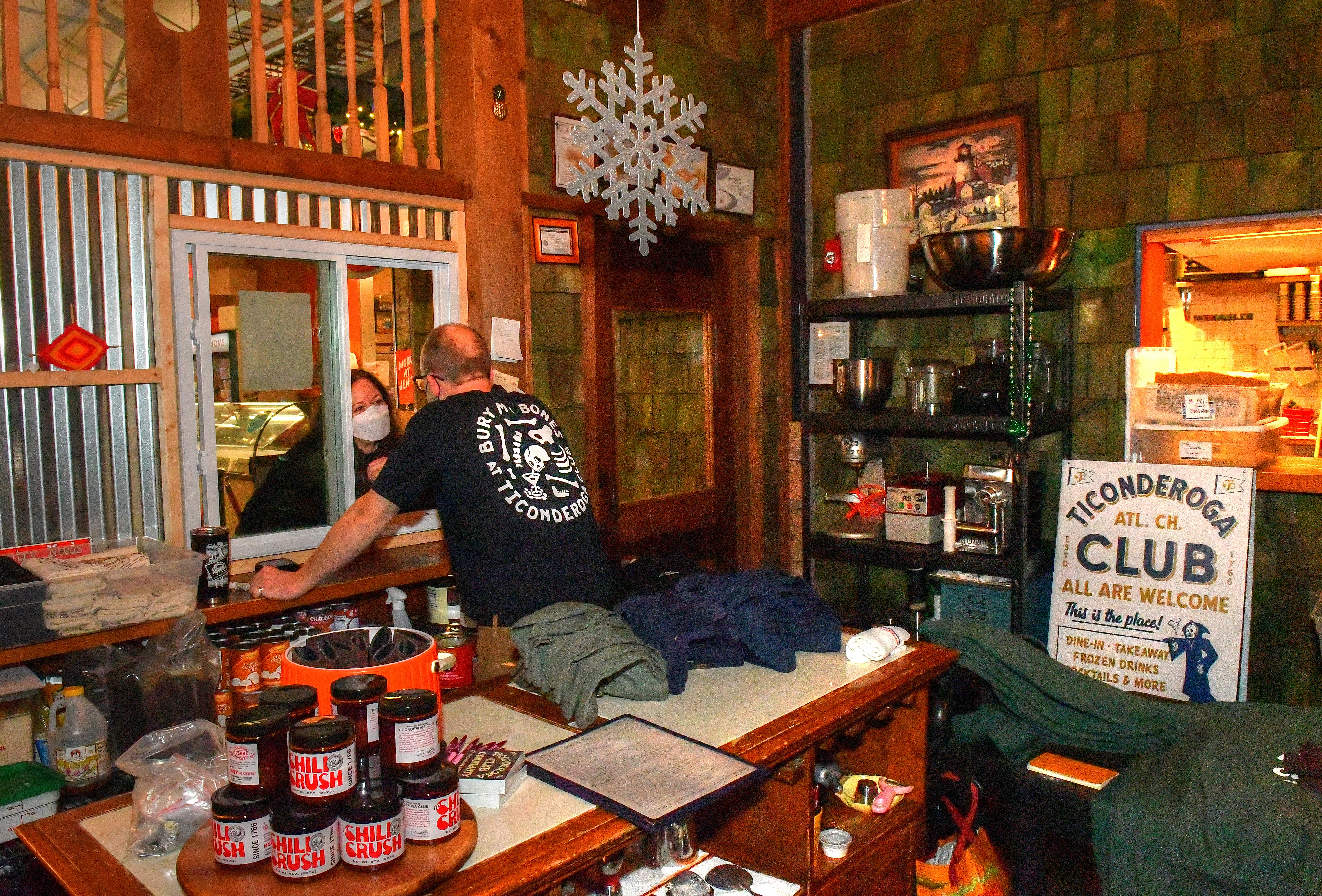 211220 Atlanta, Ga: Ticonderoga Club co-owner Greg Best (at window) converses with a walk-up customer at the Club's Krog Street Market. (Chris Hunt for The Atlanta Journal-Constitution)