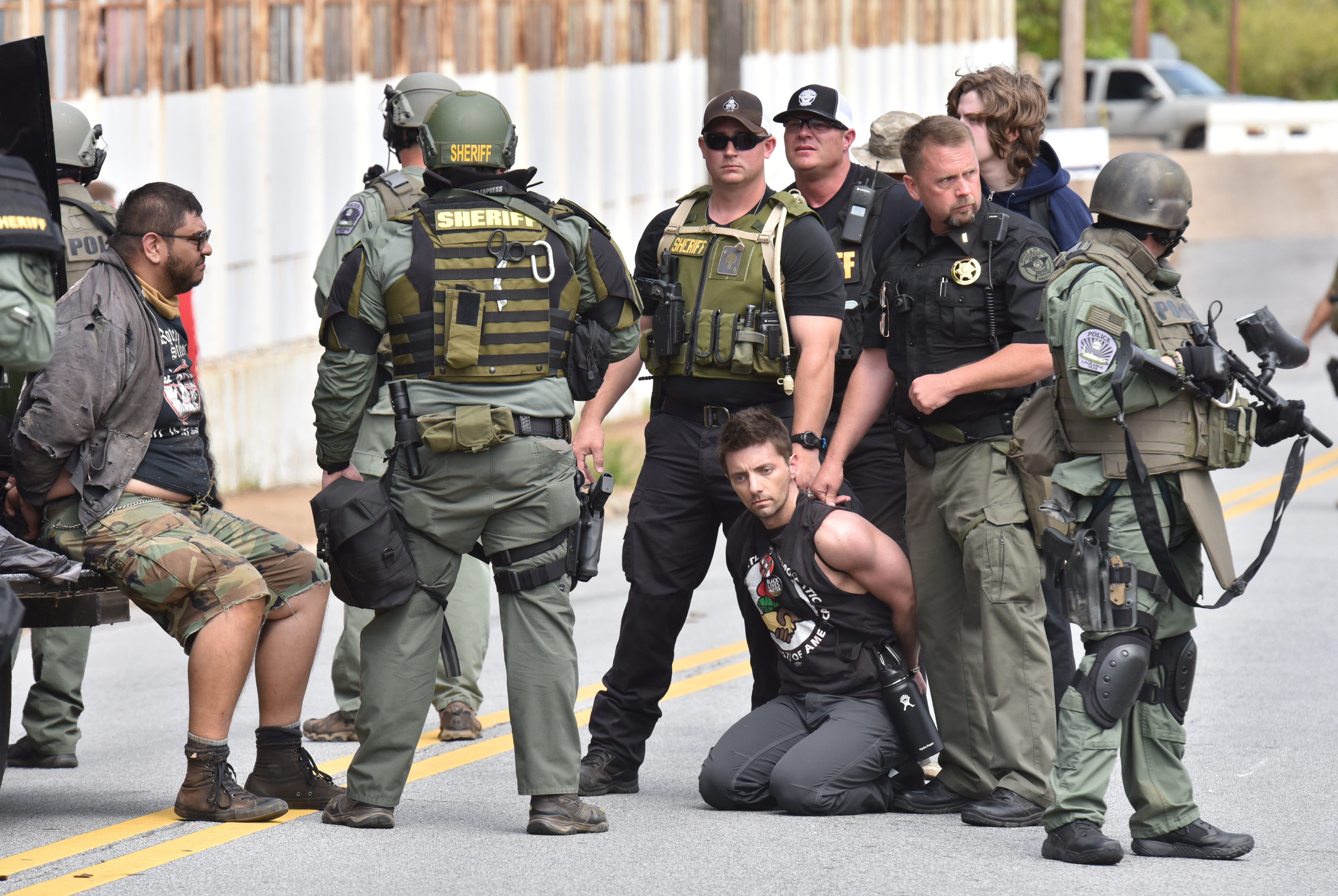 Counterprotesters are held by law enforcement officers as the National Socialist Movement holds a rally at Greenville Street Park in downtown Newnan on Saturday, April 21, 2018. The far-right hate group also drew anti-fascist demonstrators as well as hundreds of police officers.