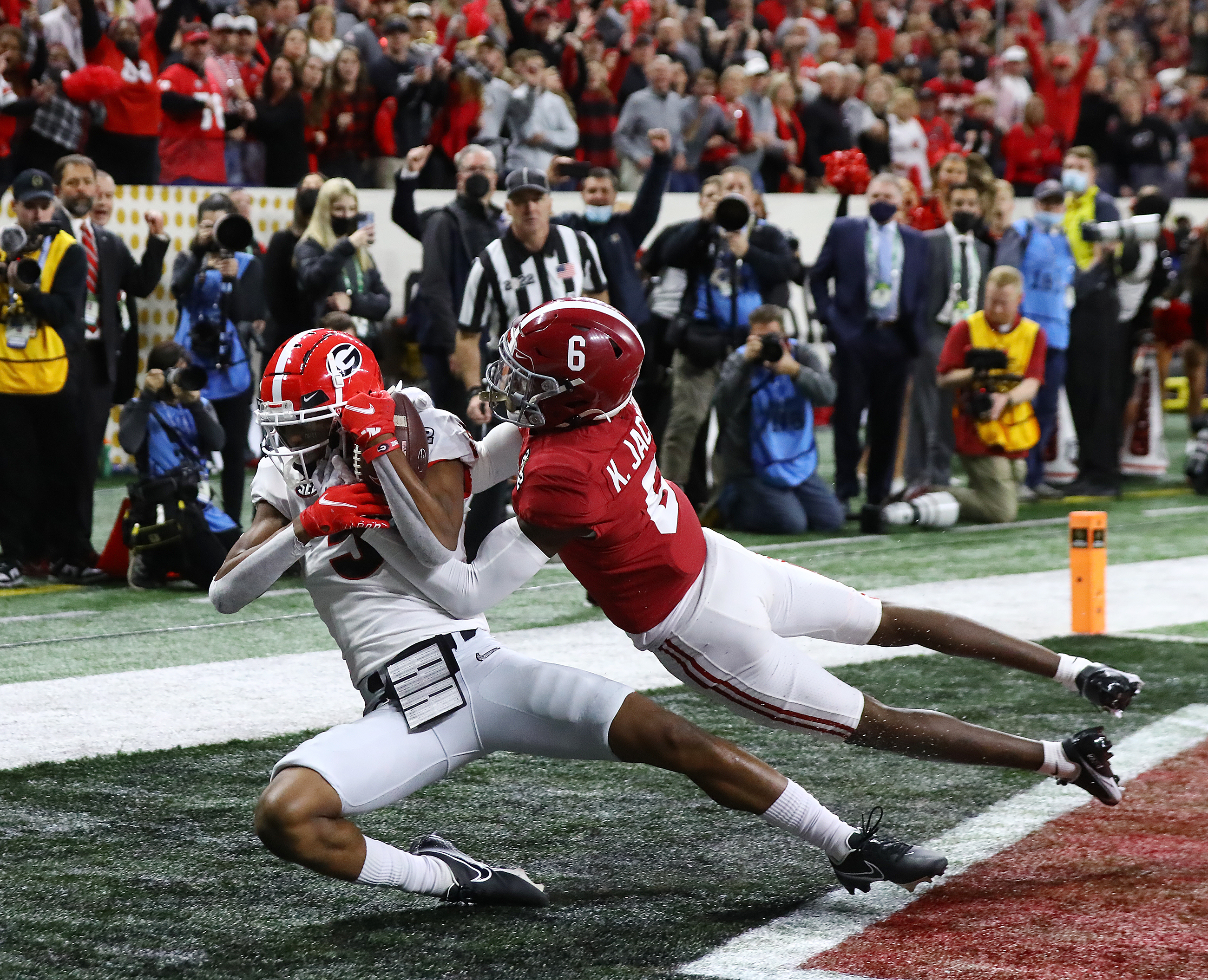 Georgia wide receiver Adonai Mitchell catches the go-ahead touchdown against Alabama defensive back Khyree Jackson to take a 19-18 lead during the 4th quarter in the College Football Playoff Championship game on Monday, Jan. 10, 2022, in Indianapolis. “Curtis Compton / Curtis.Compton@ajc.com”`