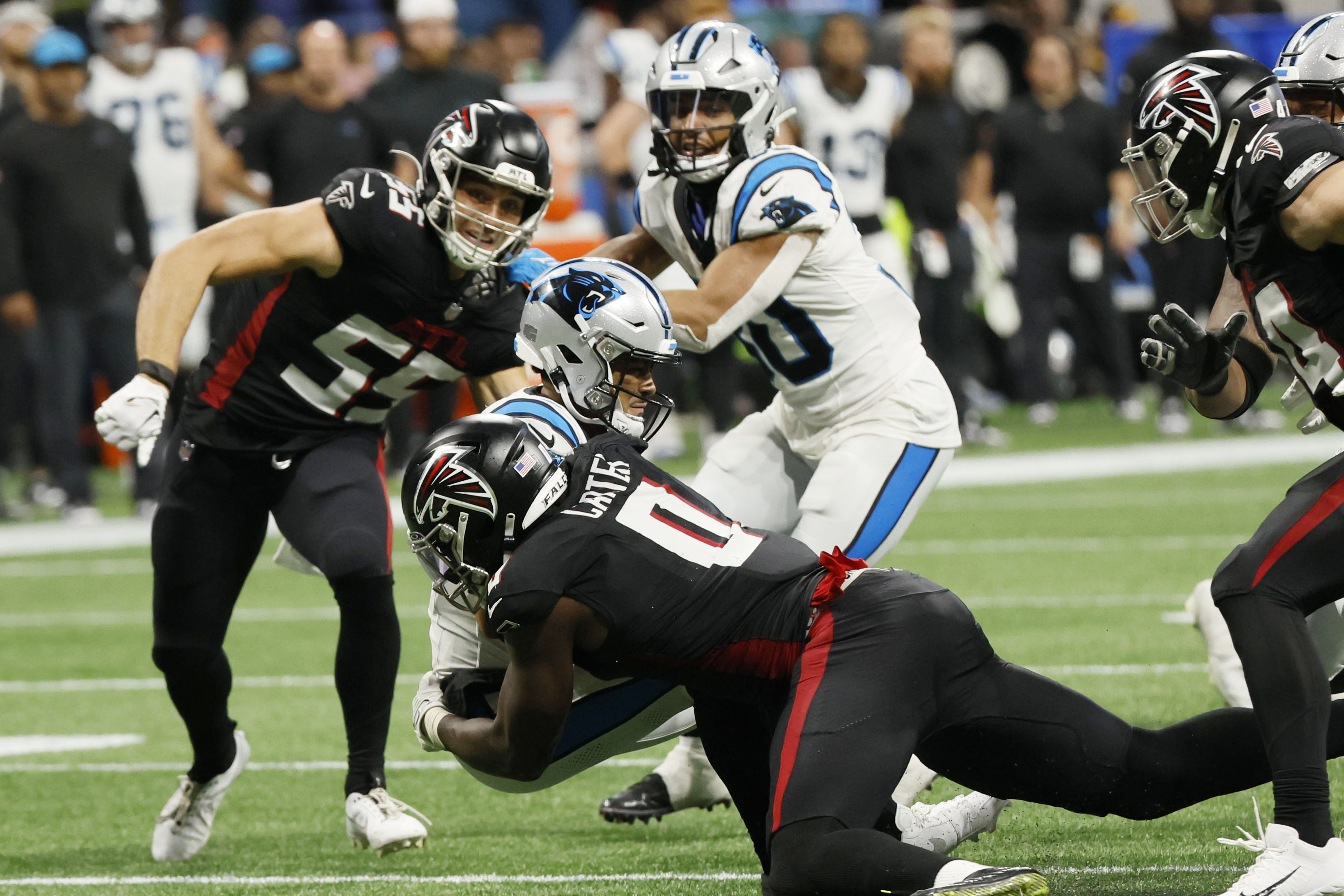 Carolina Panthers defensive tackle Derrick Brown (95) hits Atlanta Falcons  running back Tyler Allgeier (25) during