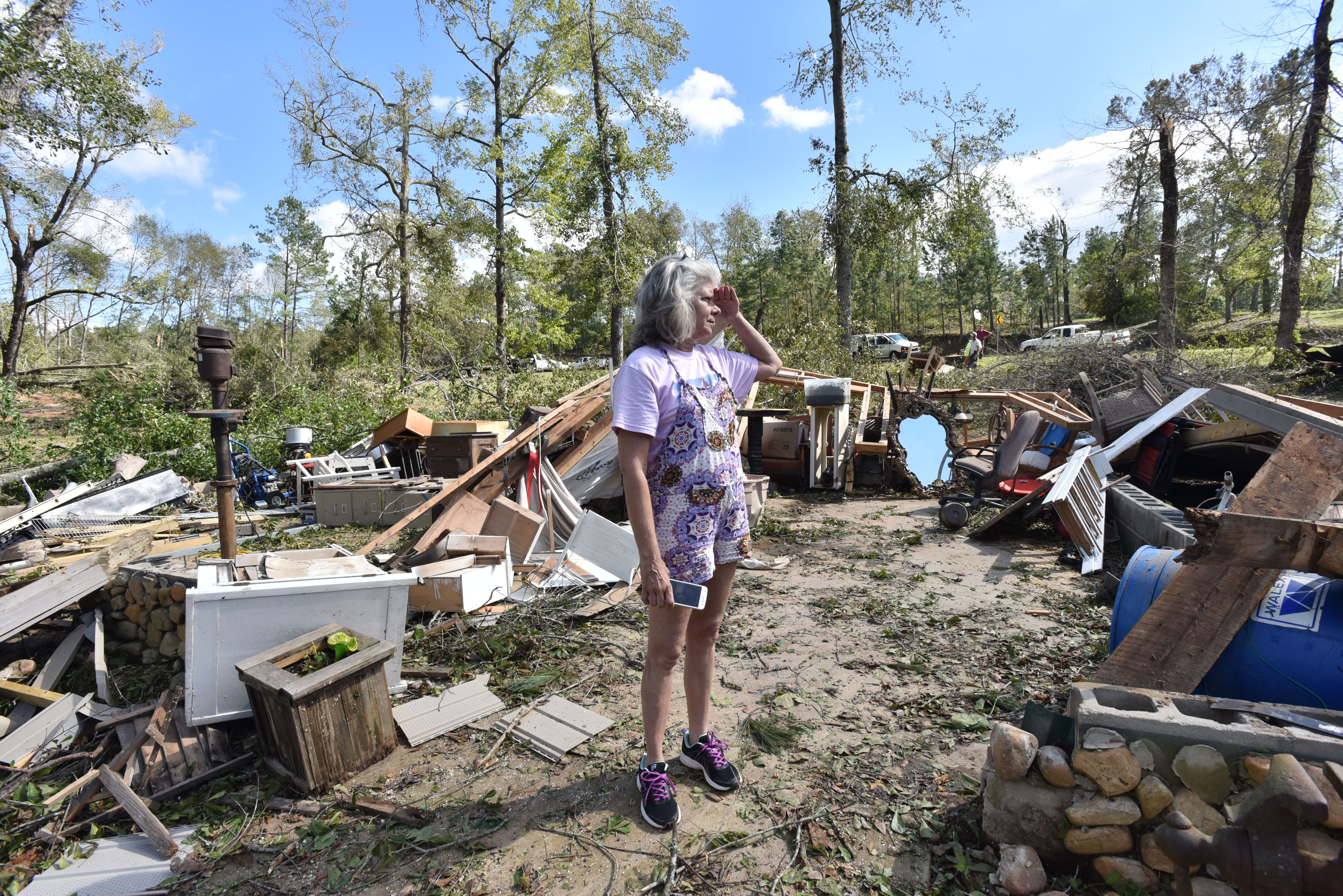 Sharon Granade stands on destroyed two-car garage after Tropical Storm Michael passed on Flint River Estates Road in Roberta on Thursday, October 11, 2018. Tropical Storm Michael swept out of Georgia before sunrise, leaving a trail of destruction in its wake. HYOSUB SHIN / HSHIN@AJC.COM