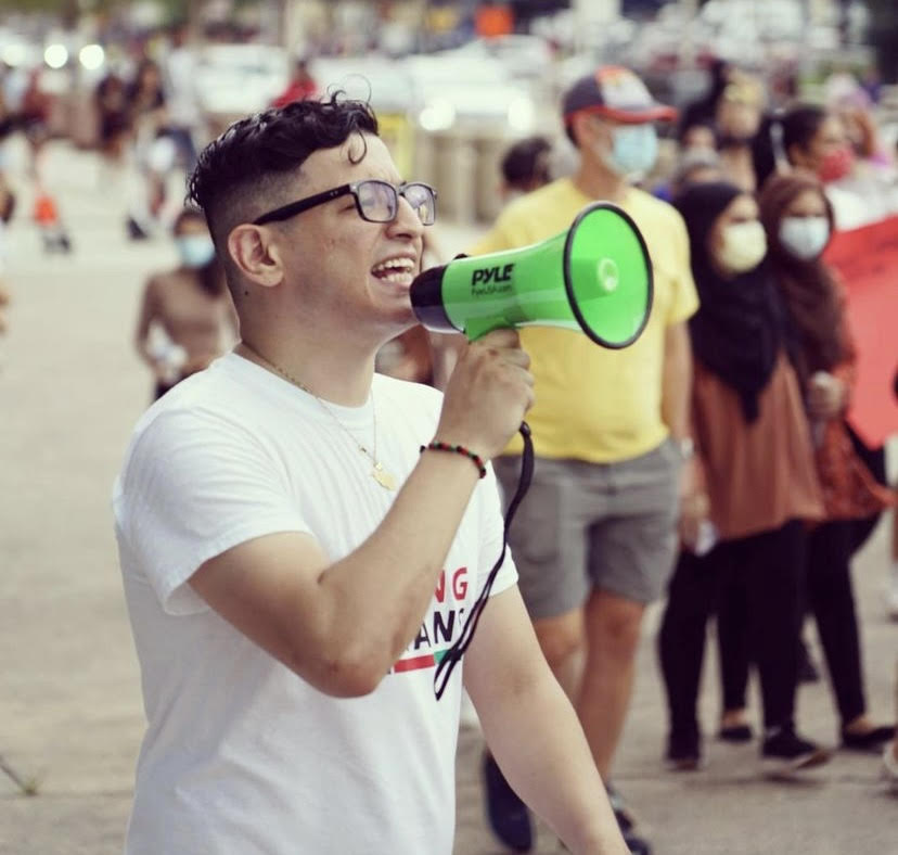 Sikandar Husseini during an August demonstration in support of Afghan citizens. Husseini was in middle school when the attacks took place, and has since used his voice to support Afghans and Muslims in his community.