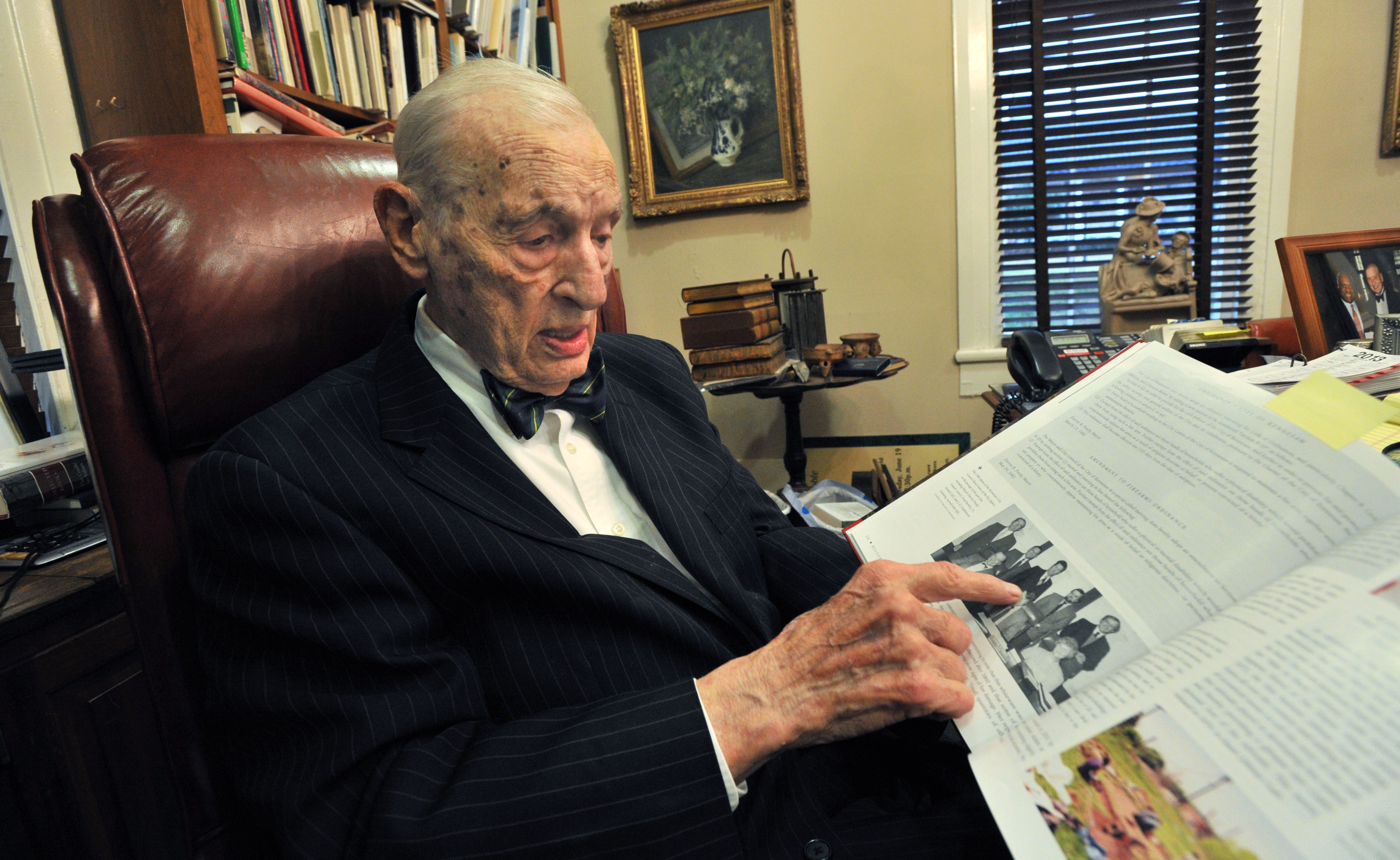 Fred Bentley Sr., in 2012, shows a copy the book, Historic Kennesaw - 1887-2012 Celebrating 125 Years. HYOSUB SHIN / HSHIN@AJC.COM