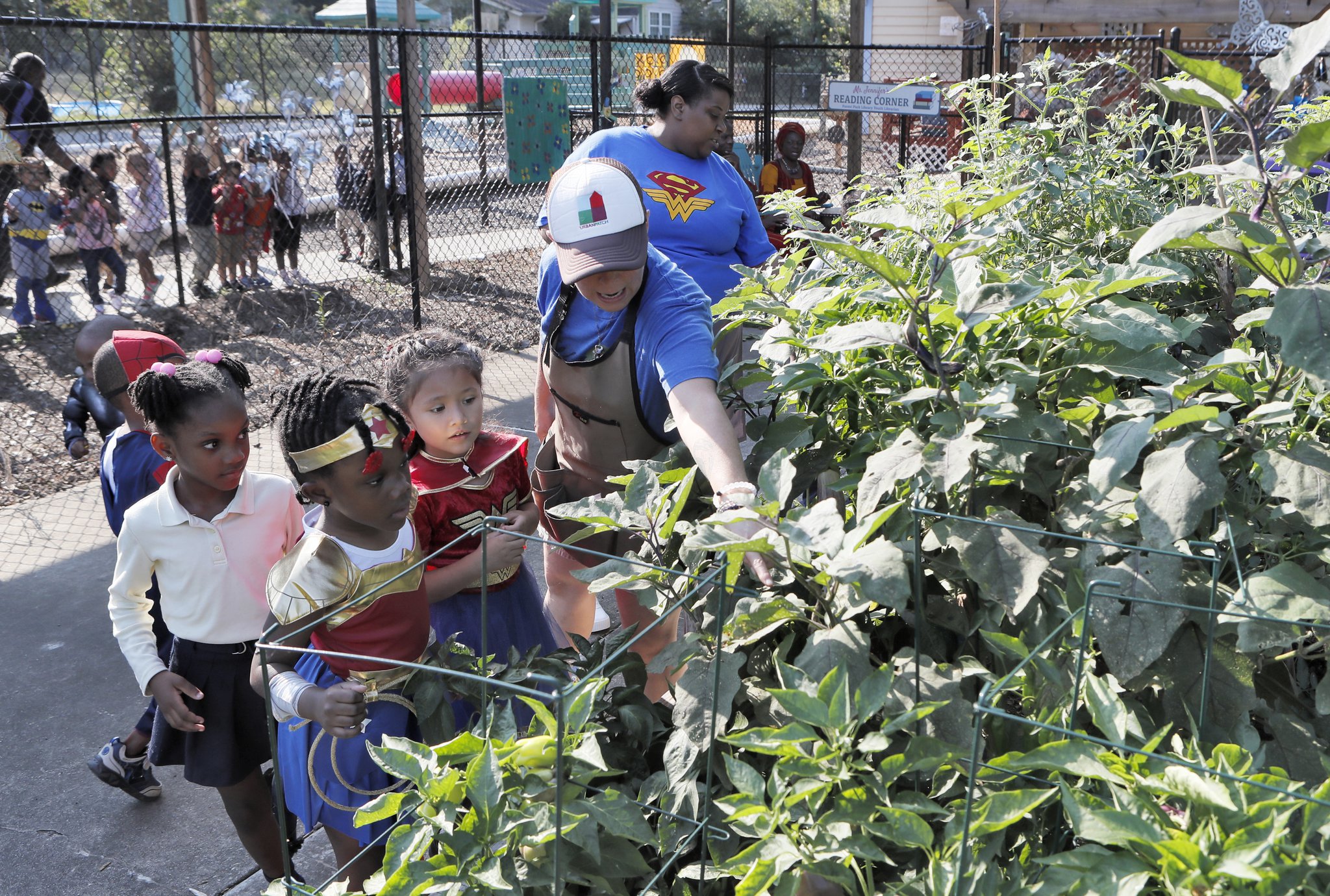 Germaine Appel (center), the garden educator at Little Ones Learning Center in Forest Park, during a session with kids in the school garden on Sept. 11, 2019.