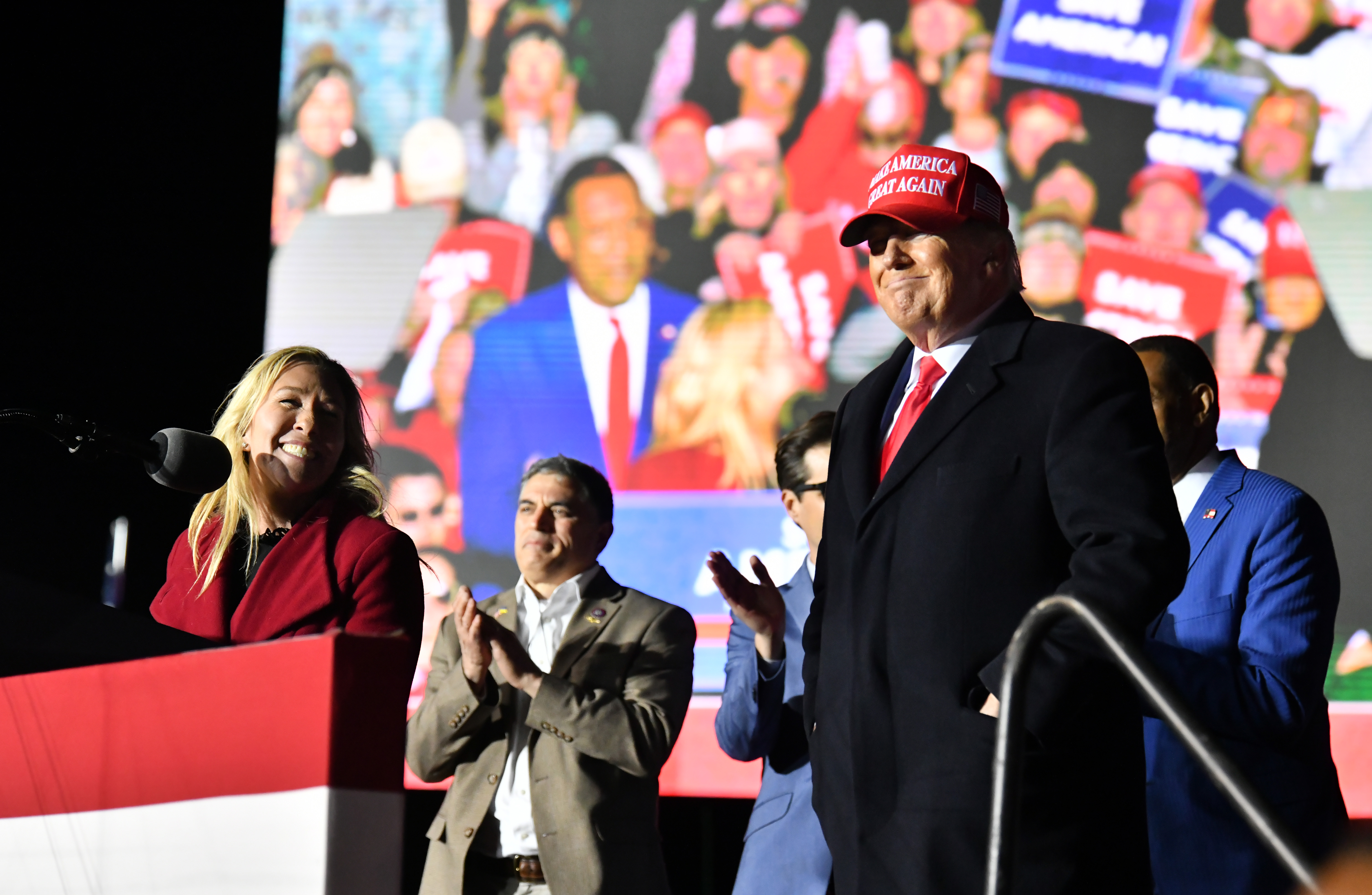 U.S. Rep. Marjorie Taylor Greene thanks former President Donald Trump during a rally for Georgia GOP candidates at Banks County Dragway in Commerce on Saturday, March 26, 2022. (Hyosub Shin / Hyosub.Shin@ajc.com)