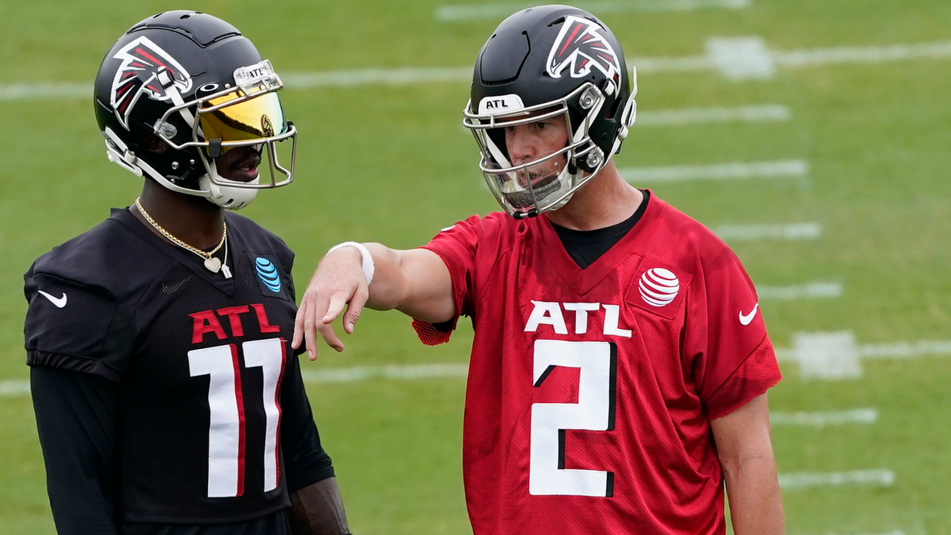 Parker Hesse and Ryan Becker of the Atlanta Falcons warm up before