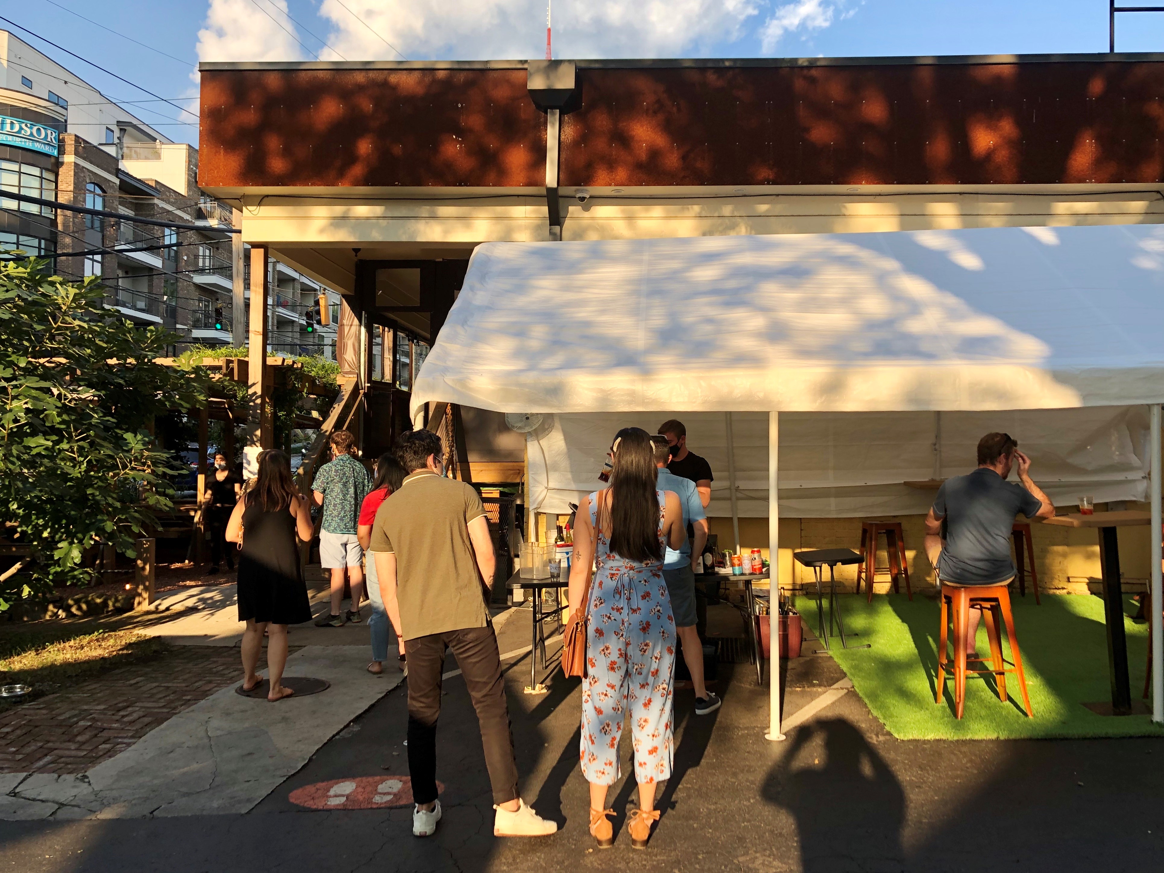 A Mano, at the corner of Ralph McGill Boulevard and Randolph Street, has put its bar outside, and added tents and tables, so customers can enjoy their takeout on the property. CONTRIBUTED BY WENDELL BROCK