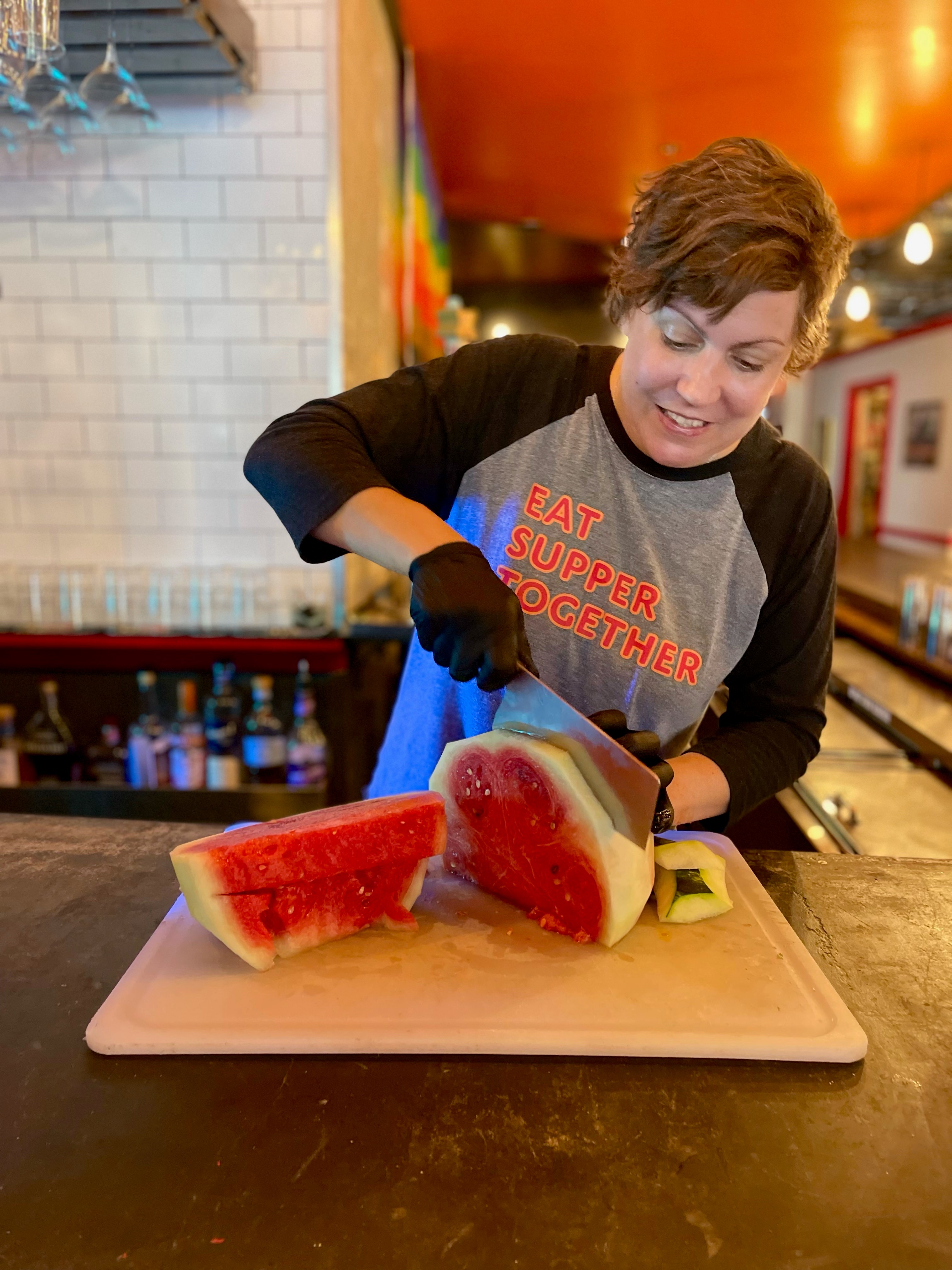 Emily Chan of JenChan’s in Cabbagetown trims the hard green rind off a watermelon in preparation for making a Watermelon-Basil Slushie. However, she saves some of the white rind to help adjust the sweetness of the slushie. (Courtesy of Jen Chan)