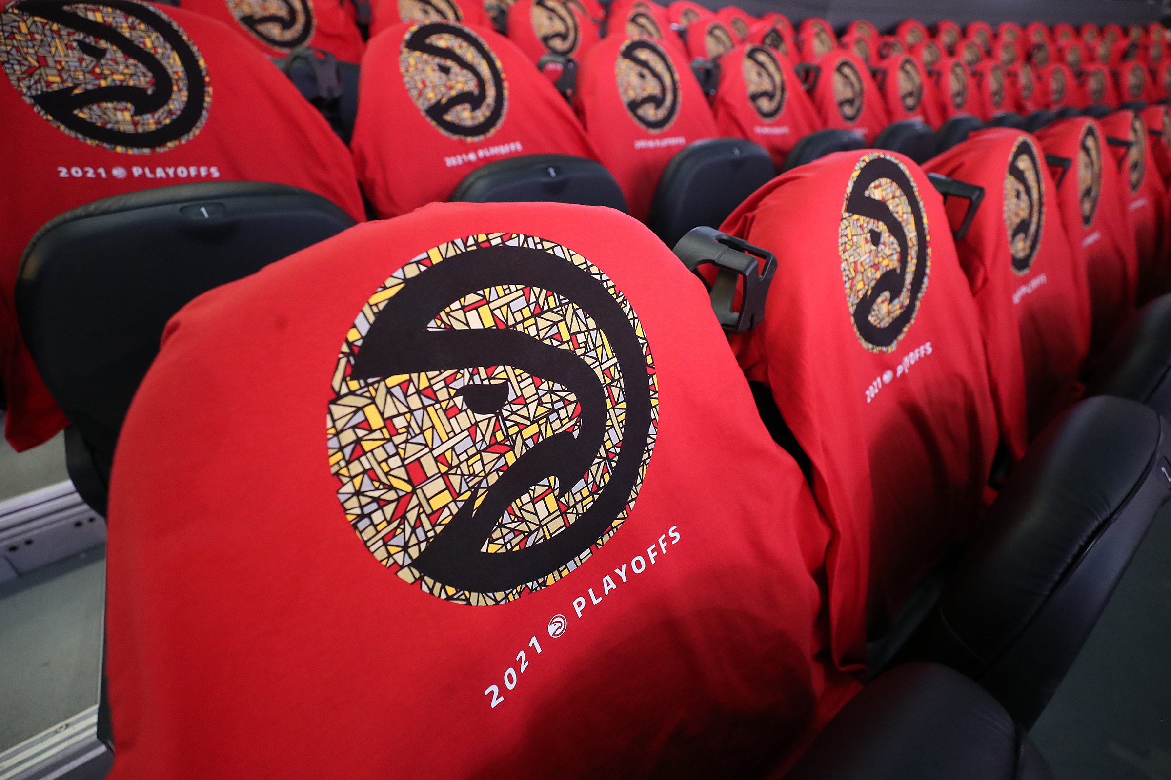 Game 4 at State Farm Arena: Playoff shirts sporting the unity stained glass logo cover the seats for fans in State Farm Arena for Monday's Game 4 of the Eastern Conference semifinals between the Hawks and 76ers.