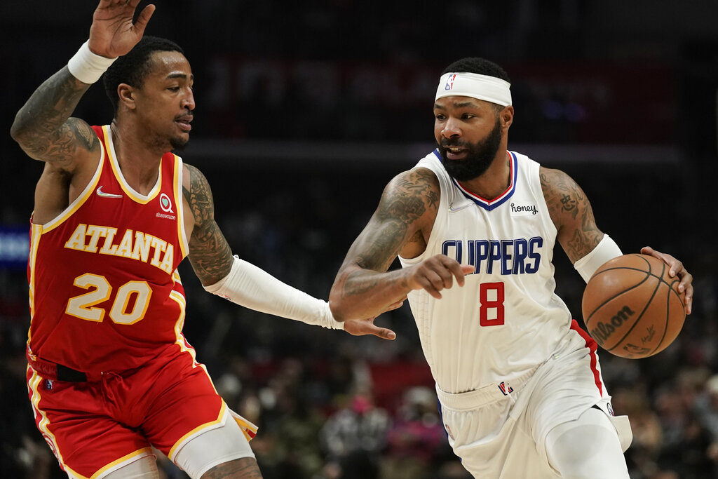 Los Angeles Clippers' Marcus Morris Sr., right, drives past Atlanta Hawks' John Collins during second half of an NBA basketball game Sunday, Jan. 9, 2022, in Los Angeles. (AP Photo/Jae C. Hong)