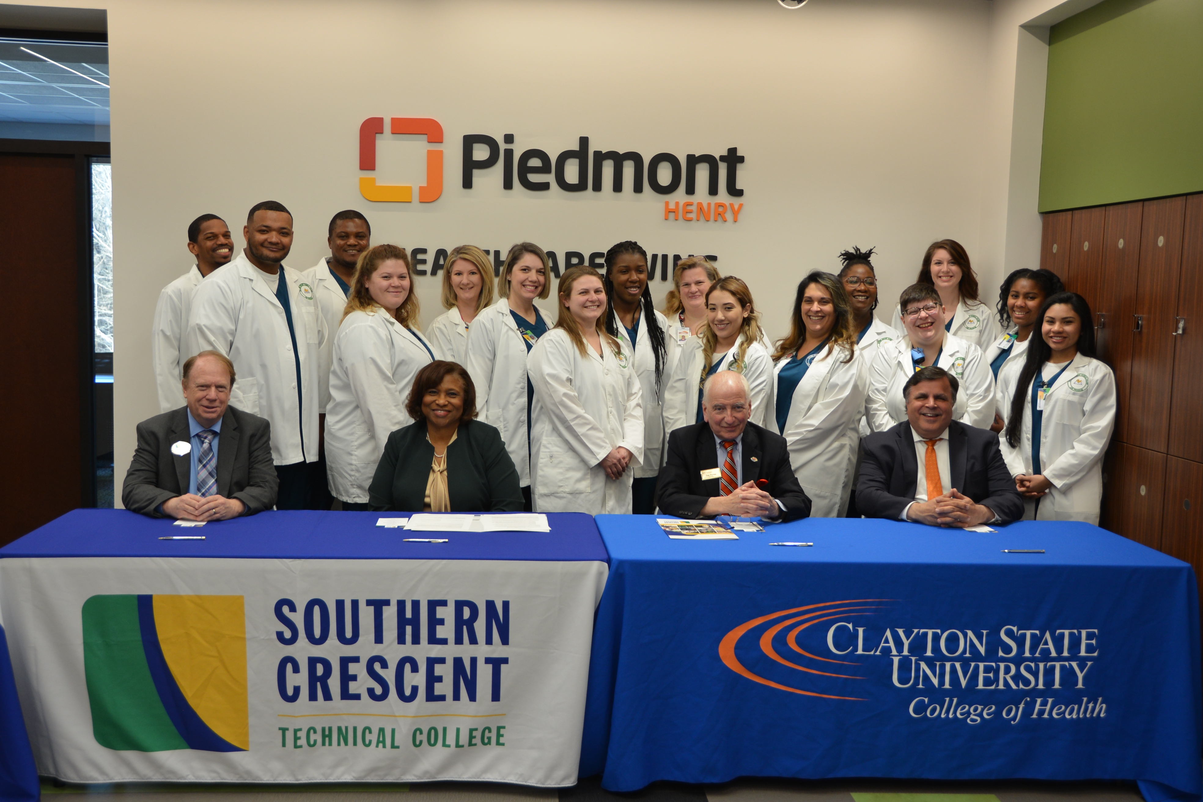 Clayton State University and Southern Crescent Technical College officials sign an agreement they hope will make it easier for Southern Crescent graduates to seek degrees from Clayton State.