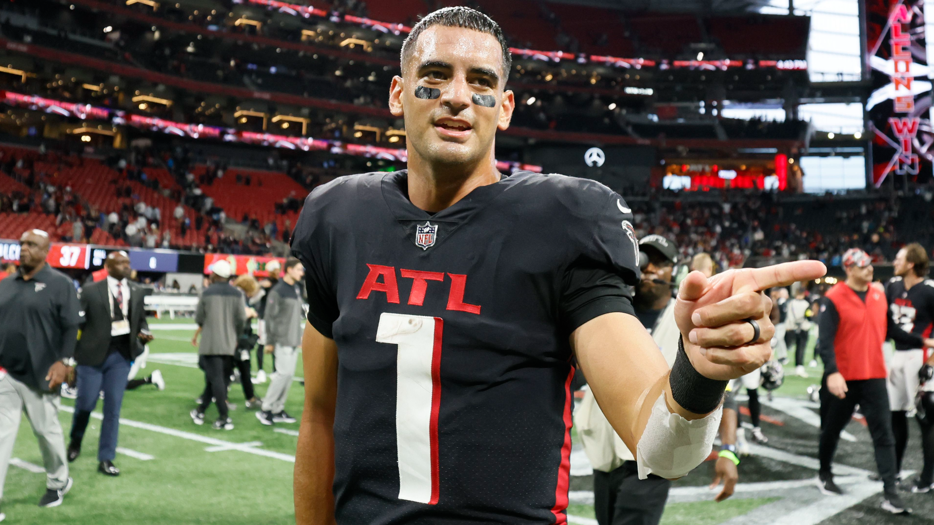 First look: Atlanta Falcons newly signed quarterback Marcus Mariota holding  his Falcons jersey, speaking with media