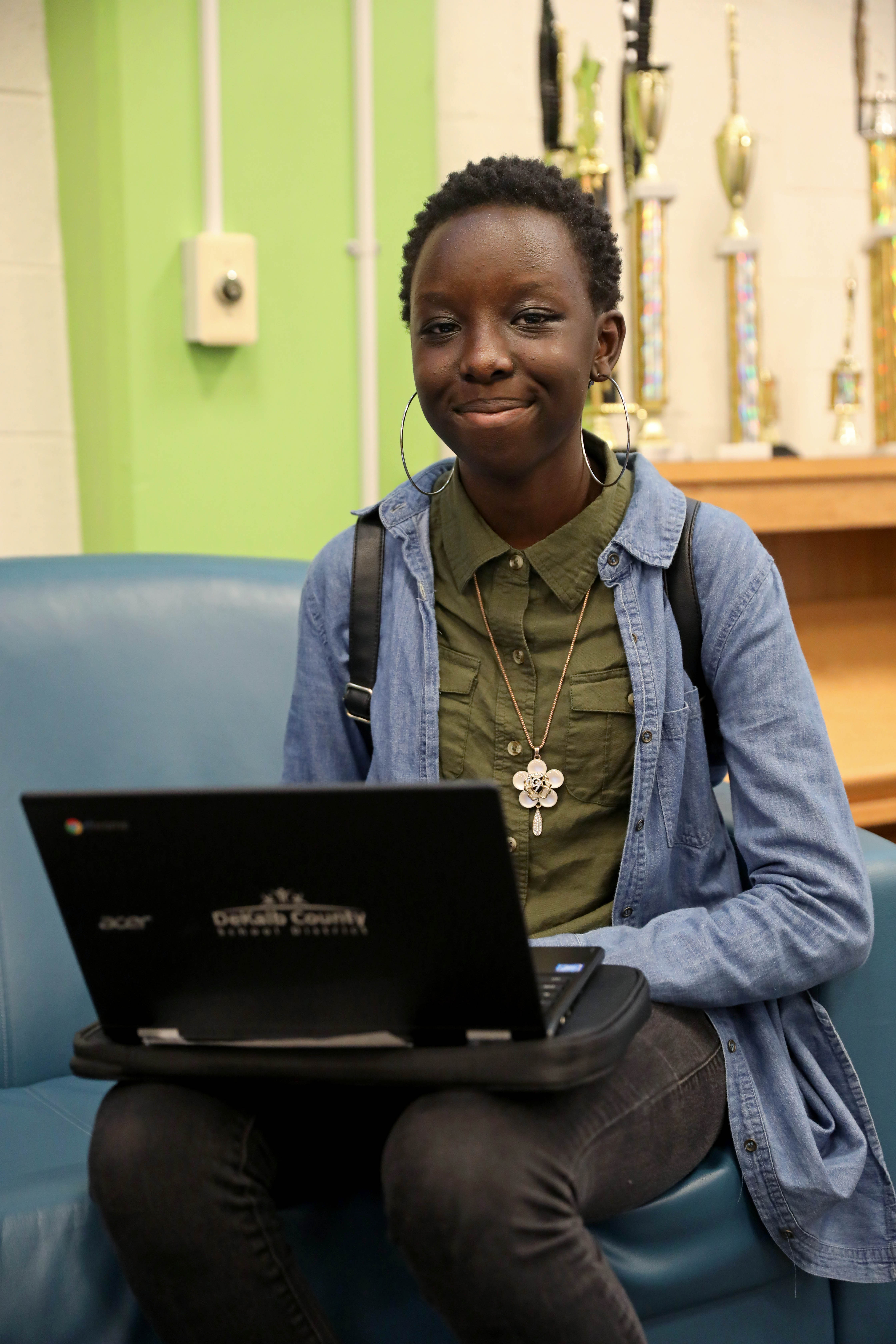 Cross Keys High School senior Joyce Korir, 17, holds her new Chromebook laptop after receiving it during the computer distribution at her school on Sept. 13, 2018, in Atlanta. (JASON GETZ/SPECIAL TO THE AJC)