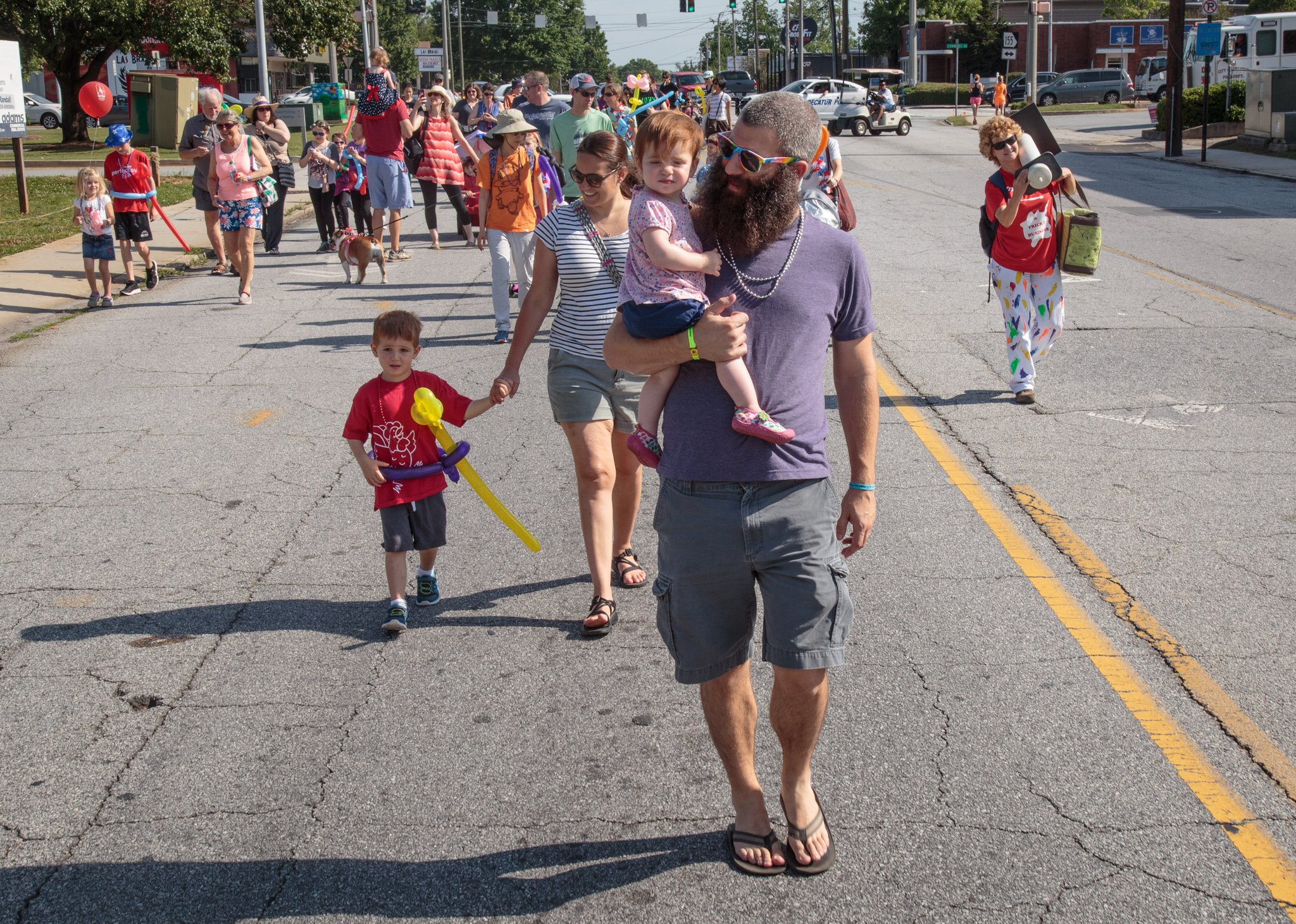 Children and their parents walk down Church Street during the kids parade that kicked off the Decatur Arts Festival on May 27, 2017.