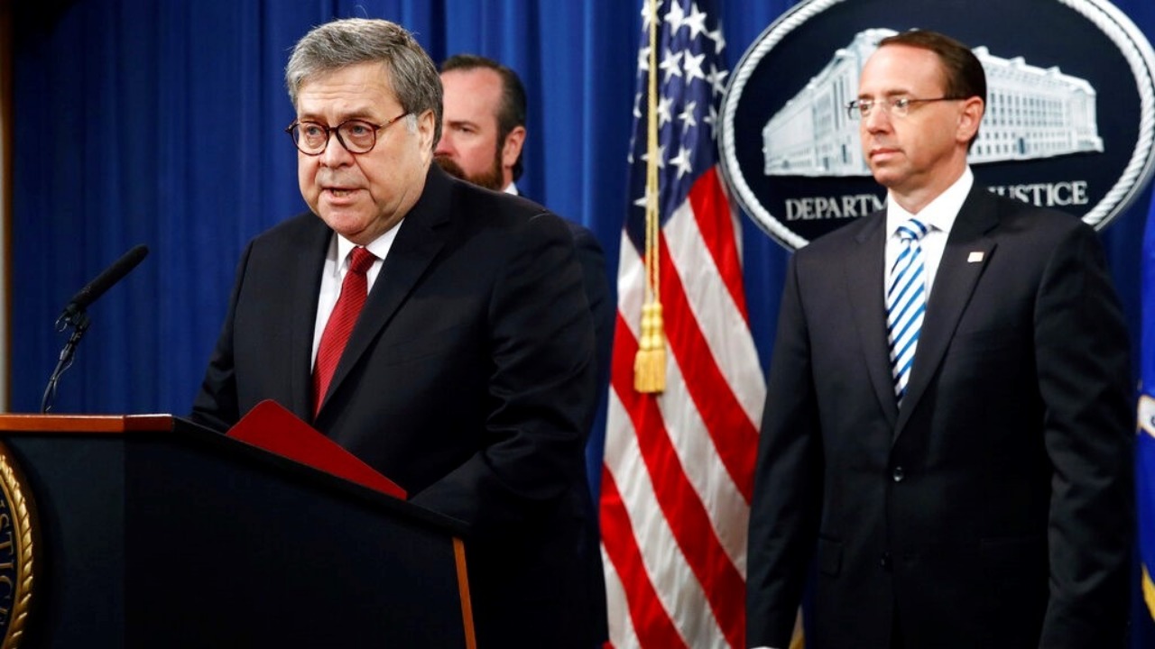 Attorney General William Barr speaks alongside Deputy Attorney General Rod Rosenstein, right, and Deputy Attorney General Ed O'Callaghan, rear left, about the release of a redacted version of special counsel Robert Mueller's report during a news conference, Thursday, April 18, 2019, at the Department of Justice in Washington.