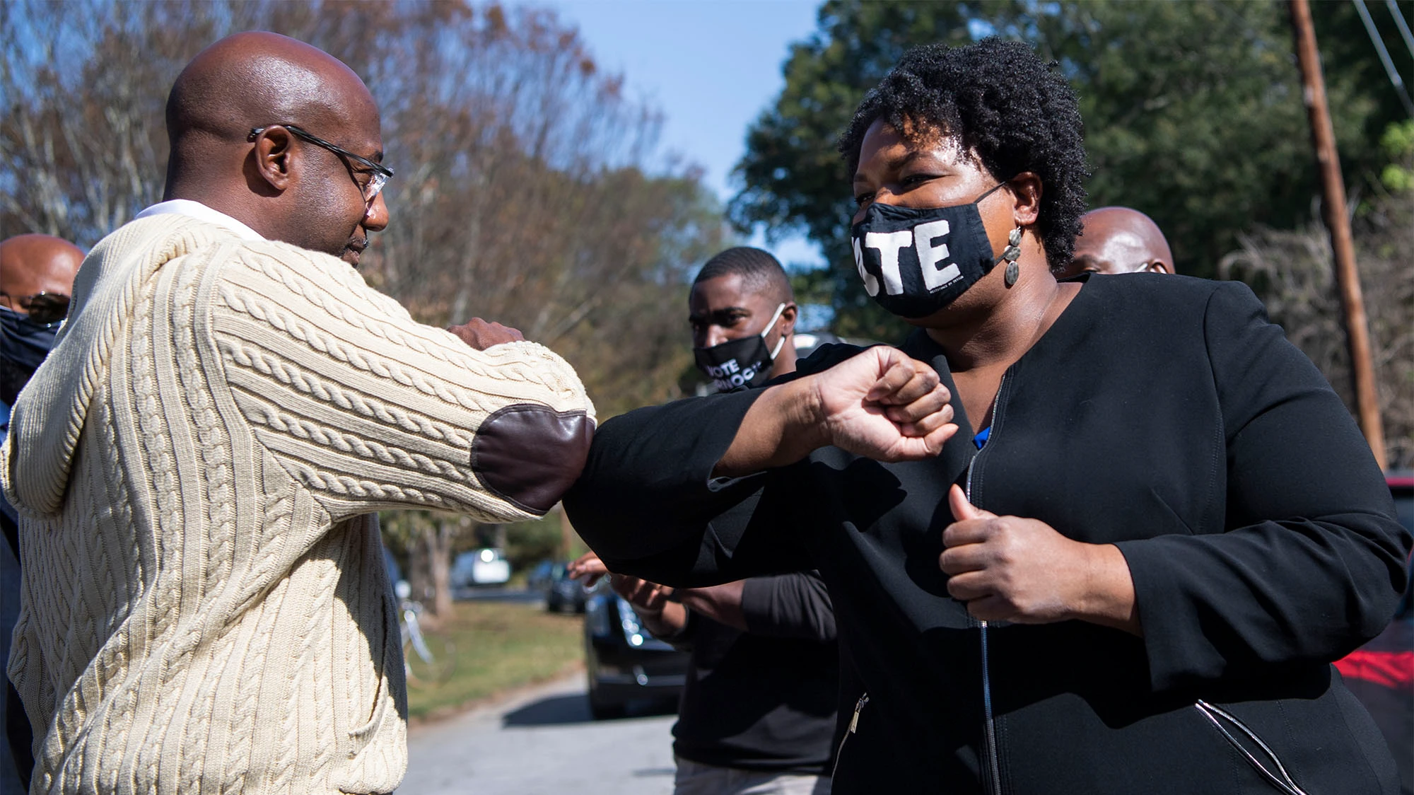 U.S. Sen. Raphael Warnock and Stacey Abrams greet each other at a 2020 event.
