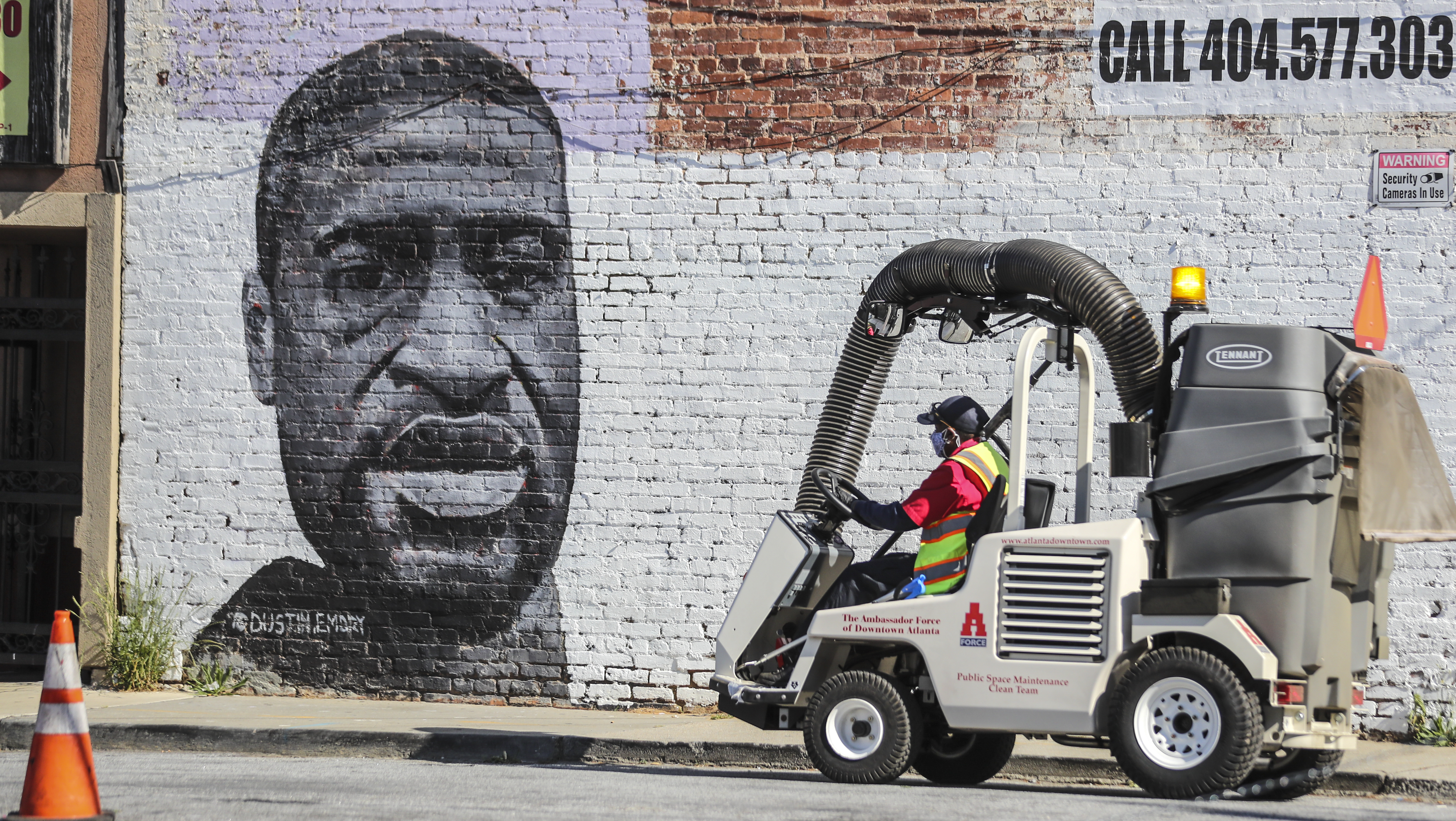April 19, 2021 Atlanta: The Ambassador Force cleaned along Simpson Street at Marietta Street in downtown Atlanta on Monday, April 19, 2021 where a large mural of George Floyd is painted. (John Spink / John.Spink@ajc.com)